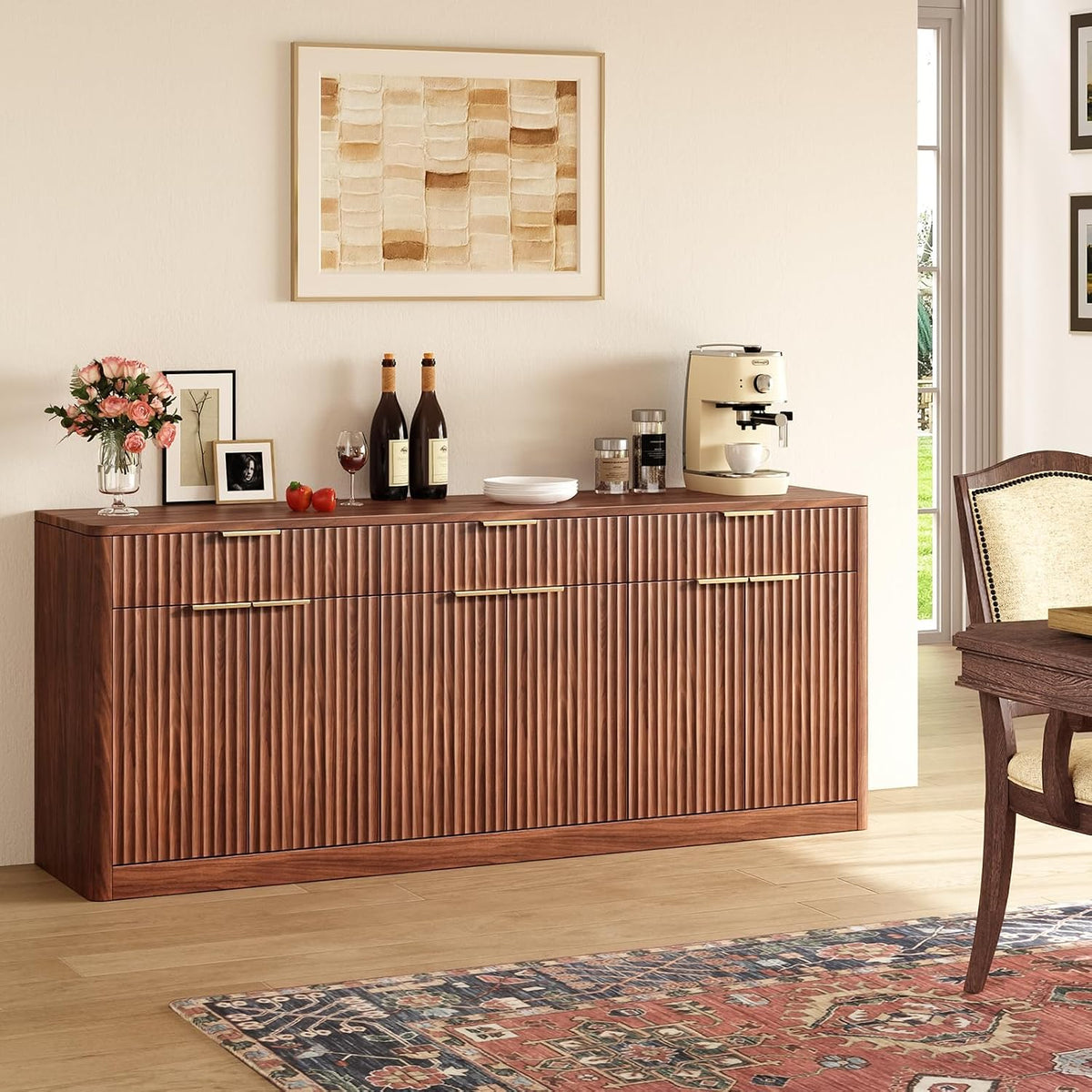 Walnut fluted sideboard against a wall with decor on top and a patterned rug in front