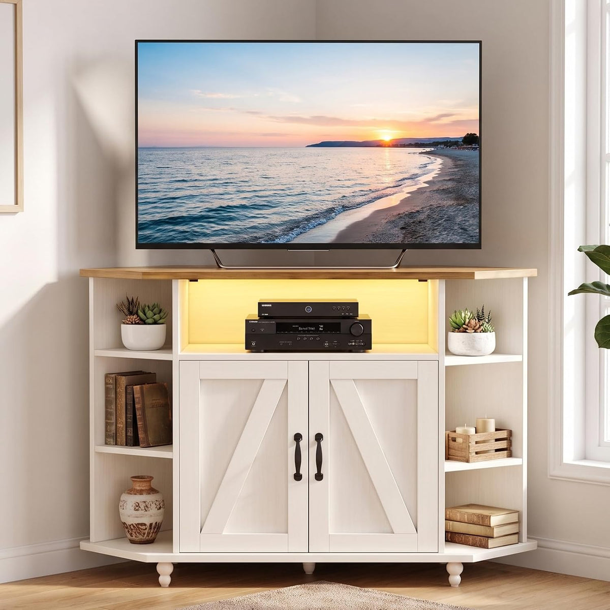 Close-up front view showing a TV on the wooden top and lit center shelf with electronics inside