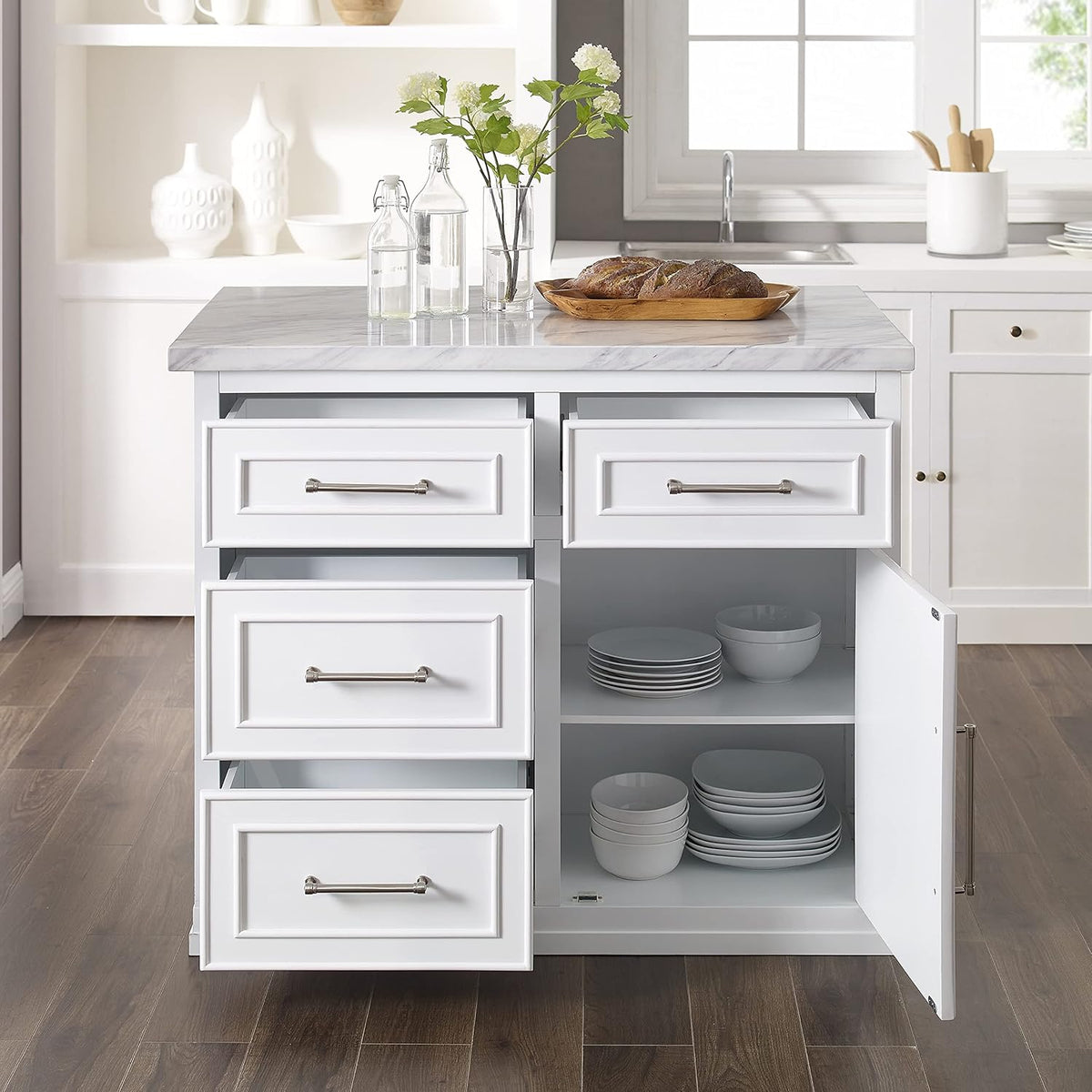 Two top drawers and lower cabinet open to show two interior shelves with neatly stacked plates and bowls