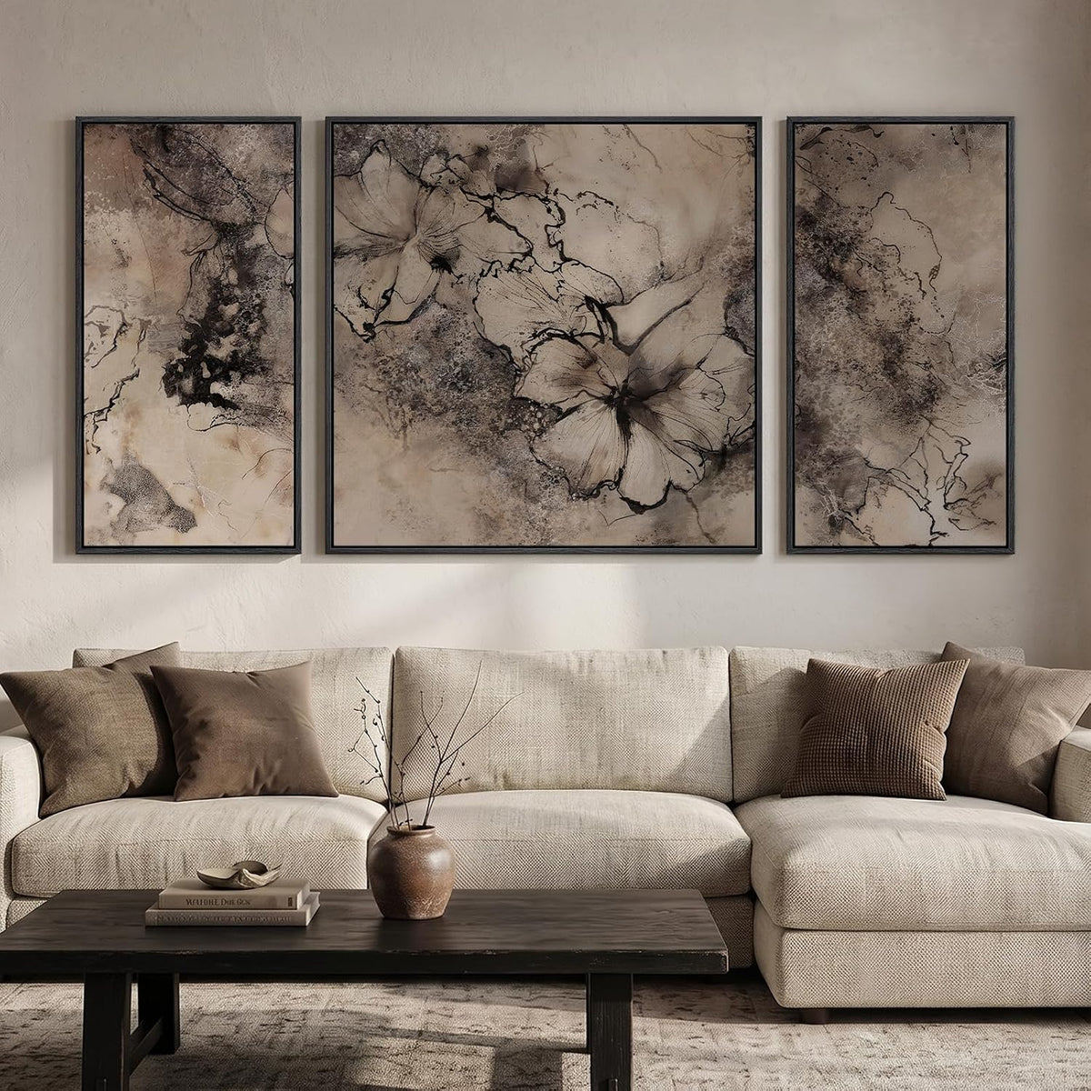Three framed panels with sepia-toned floral and marbled abstract art hung over a neutral sectional.