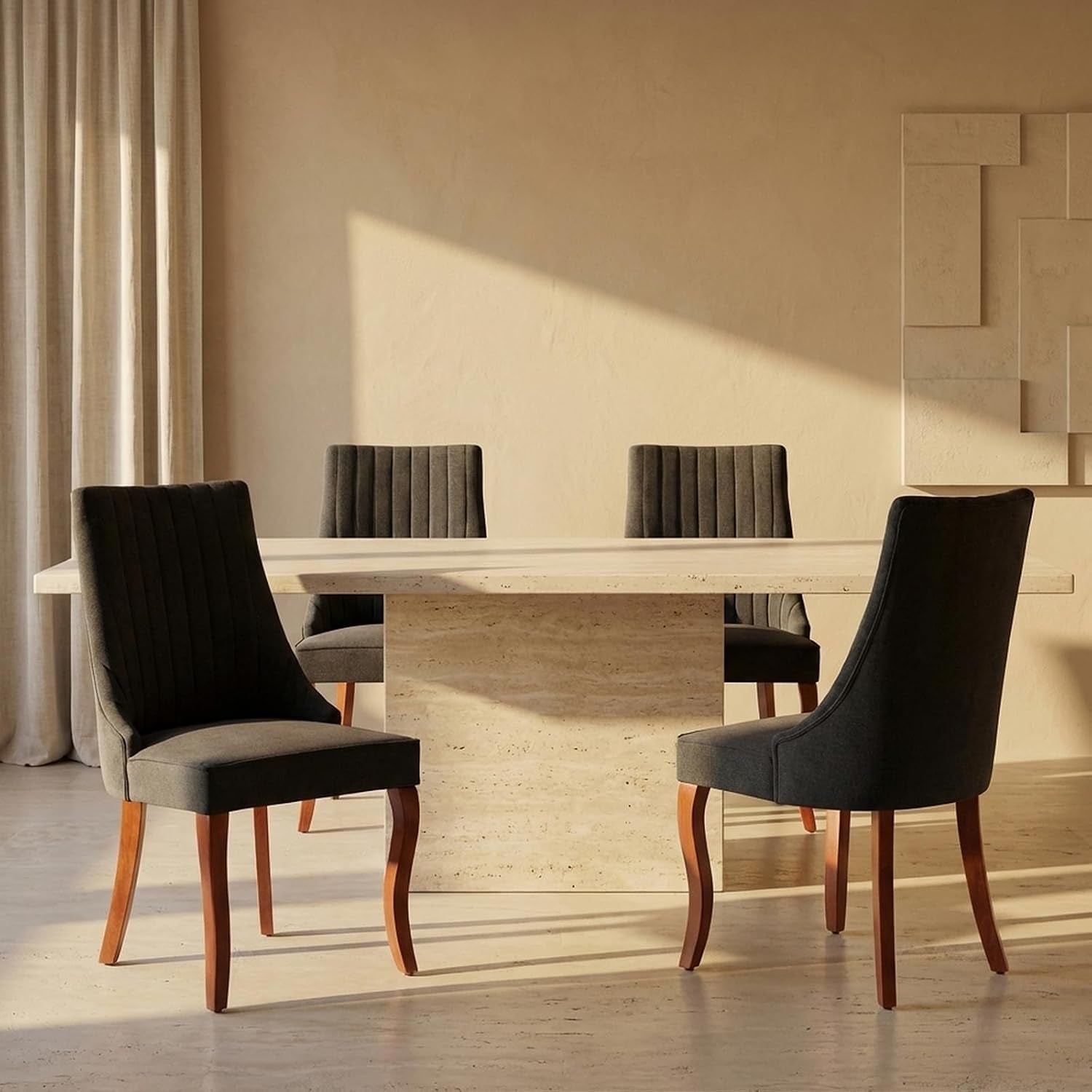 Four dark gray high-back dining chairs with wooden legs positioned around a rectangular stone table.