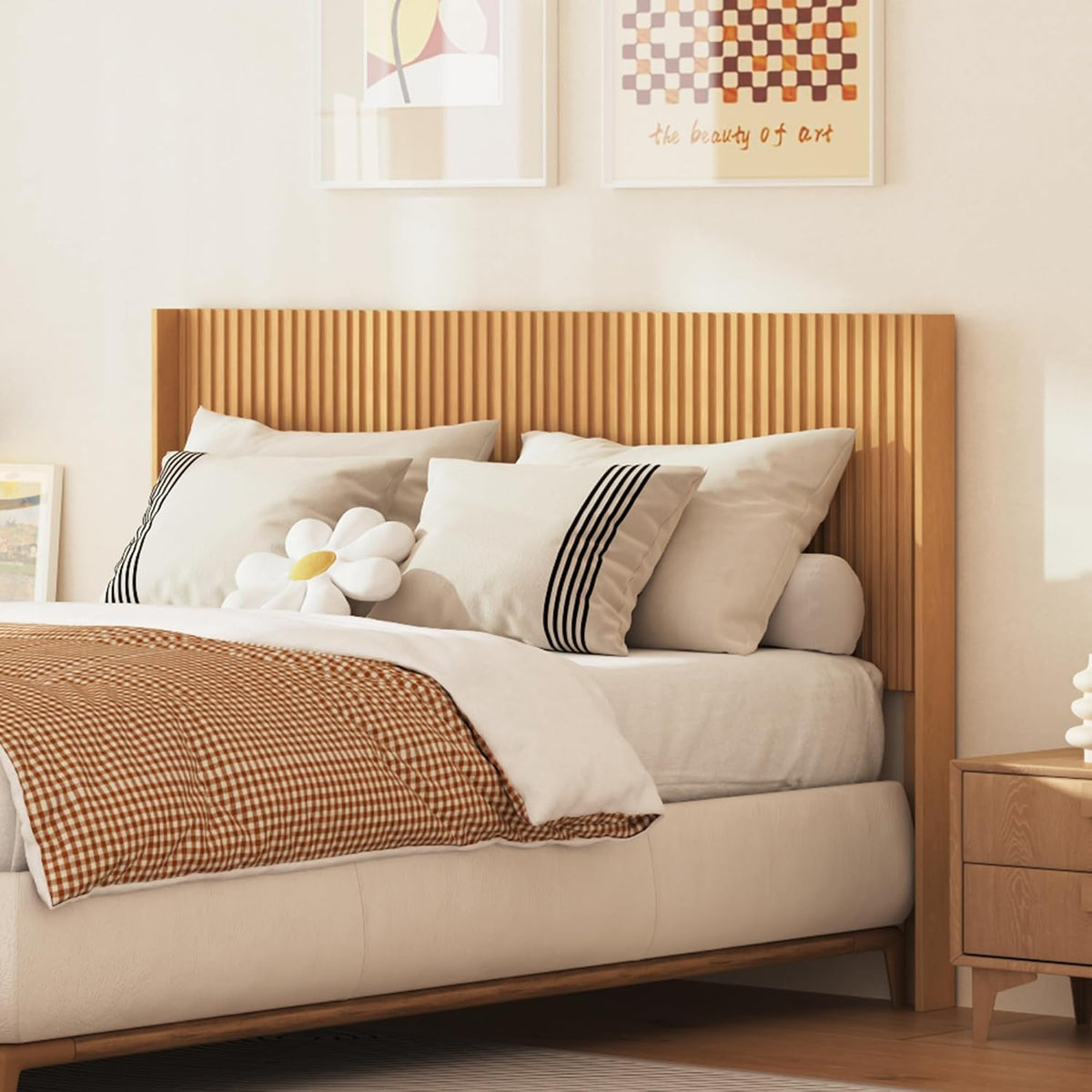 Warm bedroom scene with a light oak fluted headboard mounted behind a bed with neutral bedding.