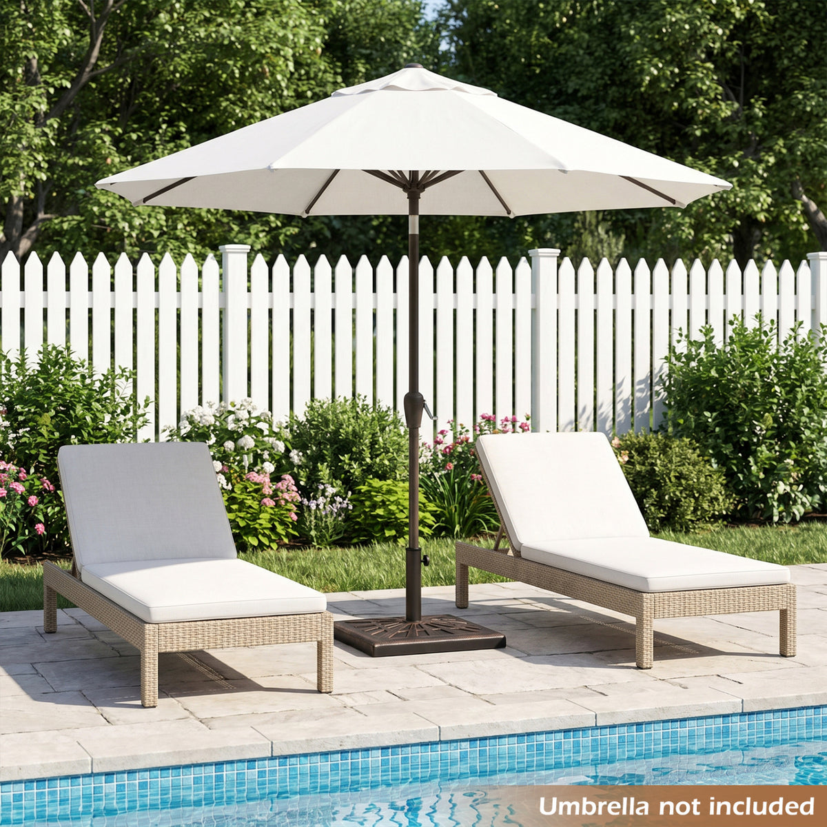 Patterned umbrella base holding a white patio umbrella beside poolside lounge chairs