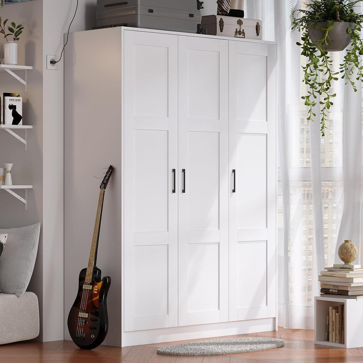 Three-door white wardrobe at room corner with a guitar leaning beside it and plants nearby.