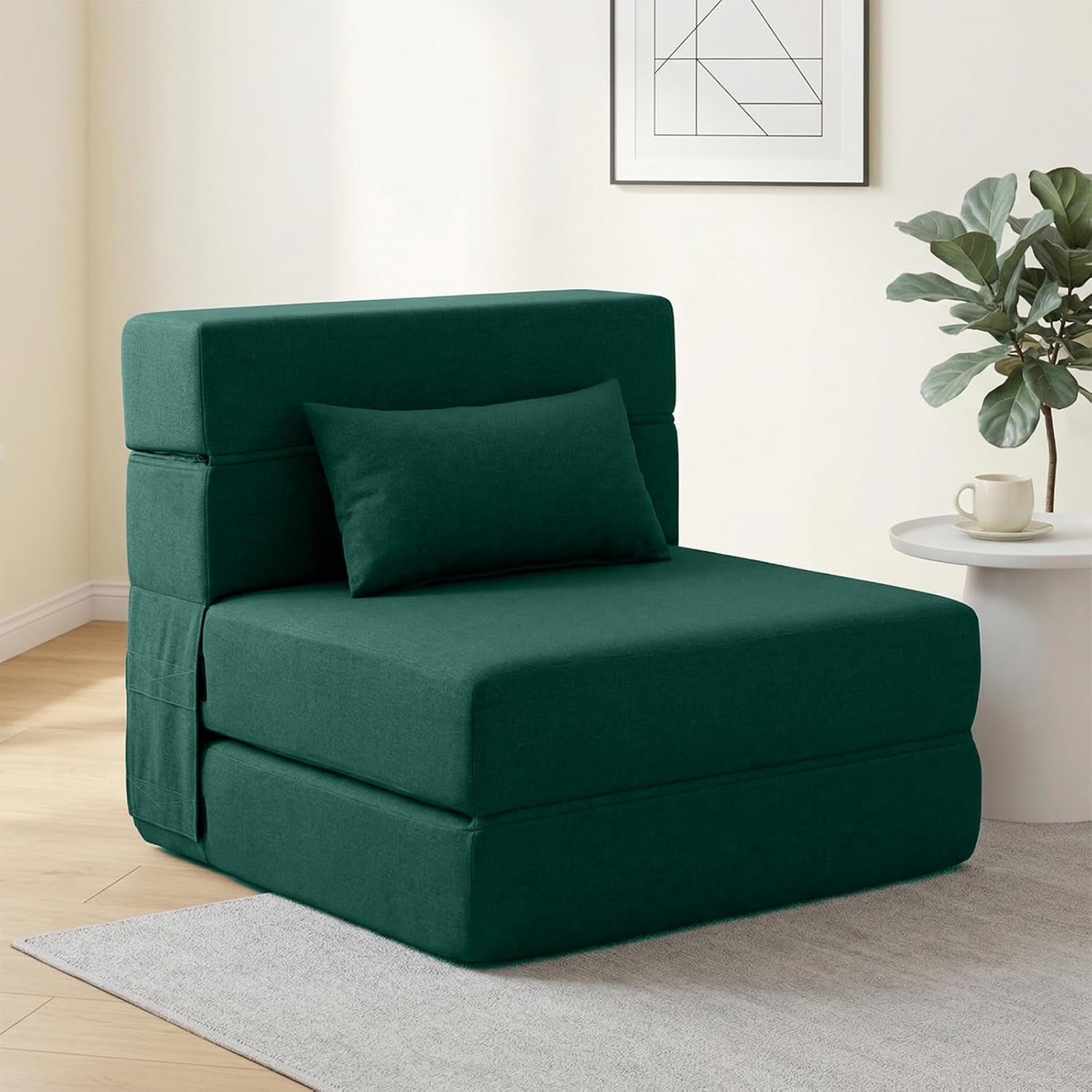 Dark green single-seat convertible sofa chair with lumbar pillow in a bright room.