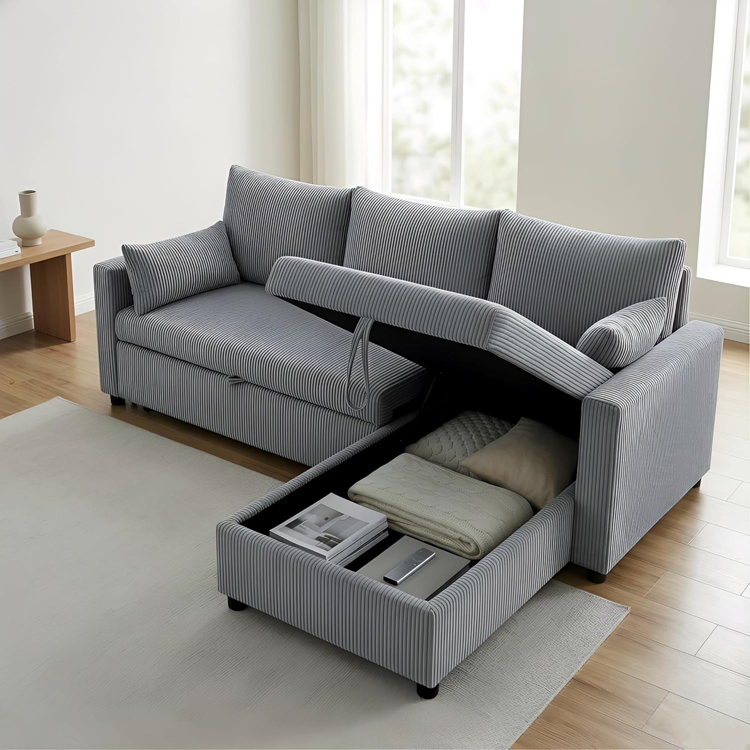 Close-up of the chaise storage box open, showing folded blankets and books inside.