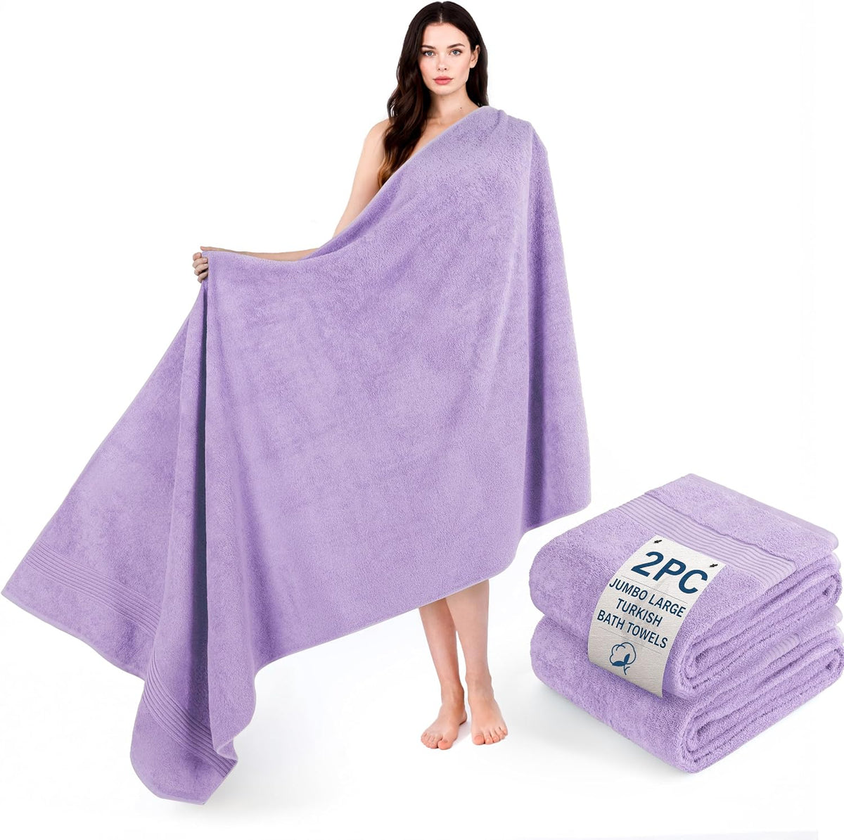 Model displaying a lavender towel wrapped around her with a stacked pair of matching folded towels at her feet.