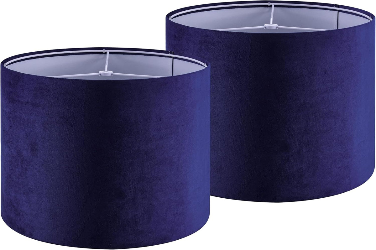 Pair of navy blue drum shades side by side, tops visible with white interior liners and spider fitters.