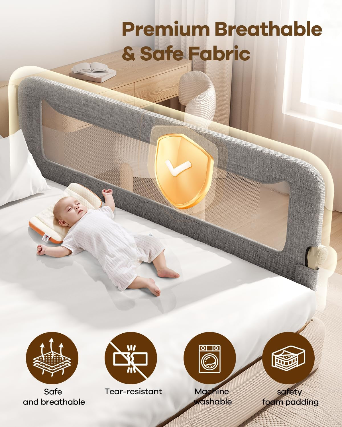 Gray mesh bed rail installed on a bed with a sleeping baby and bedroom furniture in background.