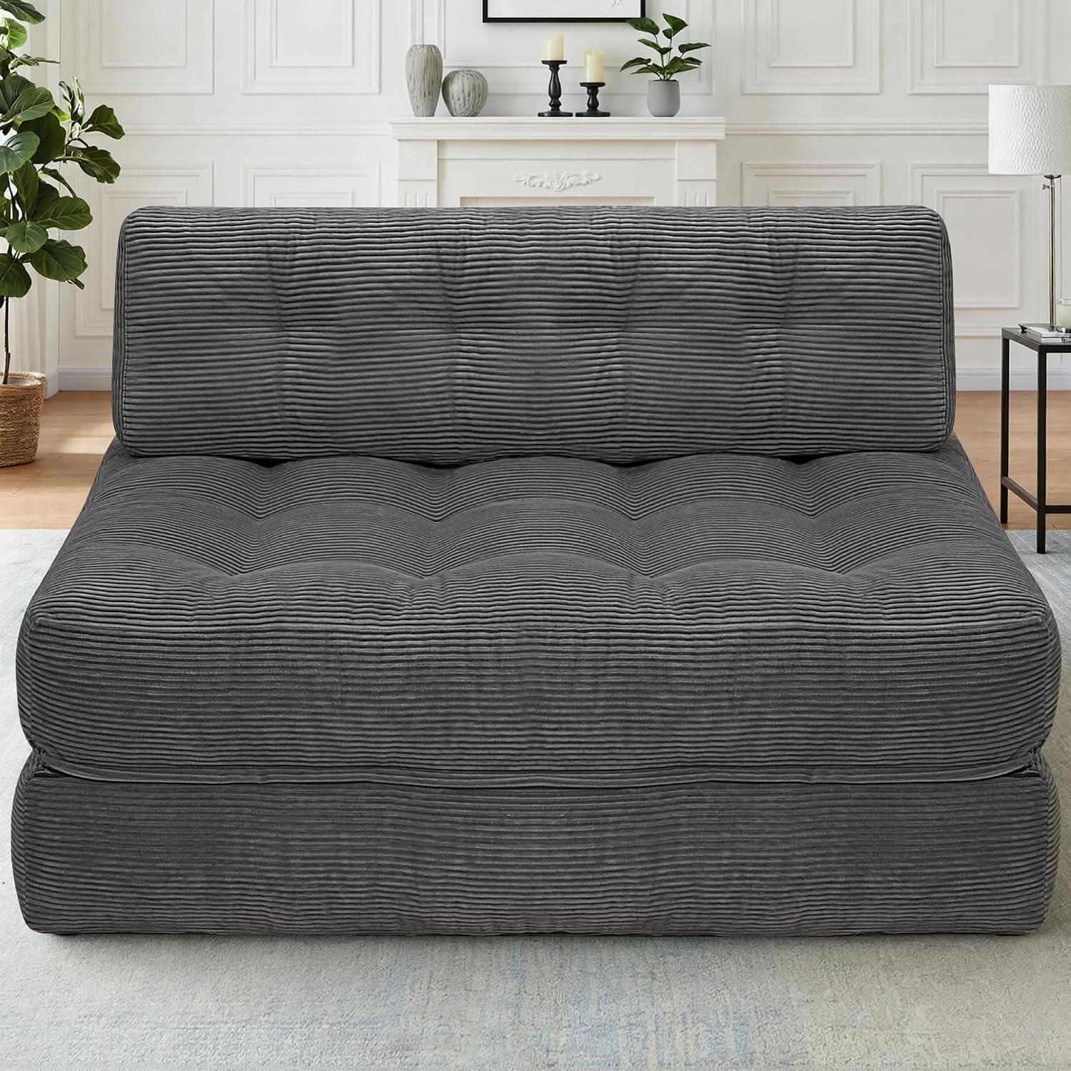 Front view of a dark gray ribbed-corduroy convertible sofa in a compact seated position.