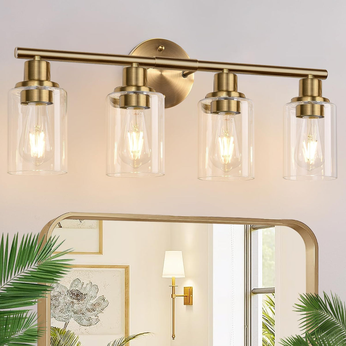 Front view of a four-light brass vanity lamp with clear glass cylinder shades and warm bulbs.