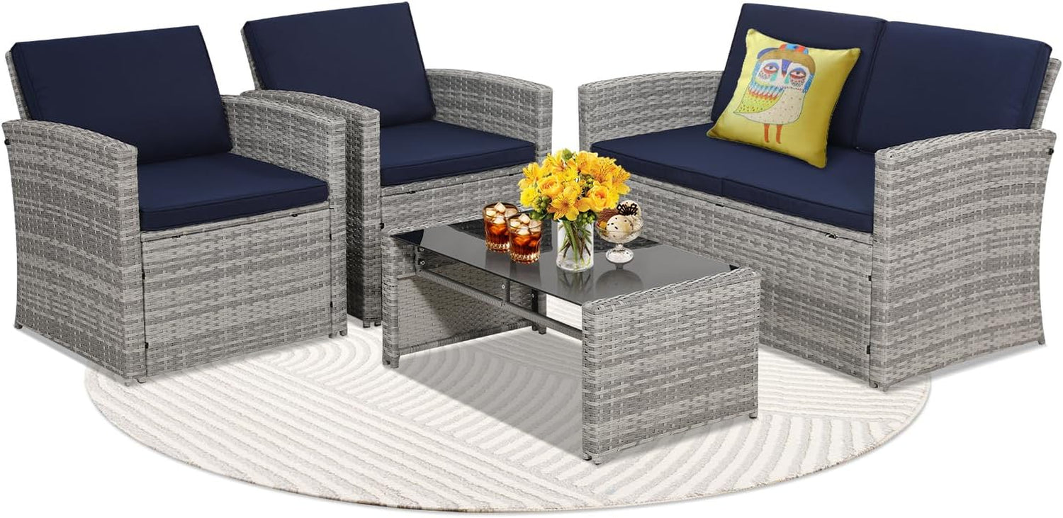 Light gray wicker loveseat and two armchairs with navy cushions and round rug, owl accent pillow on loveseat.