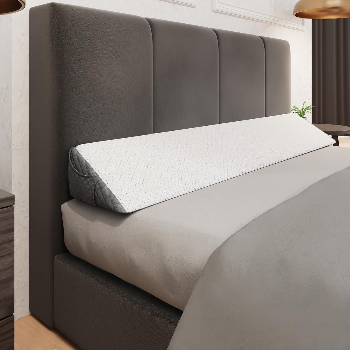 Long wedge pillow positioned horizontally along a tall upholstered headboard, showing its full slope