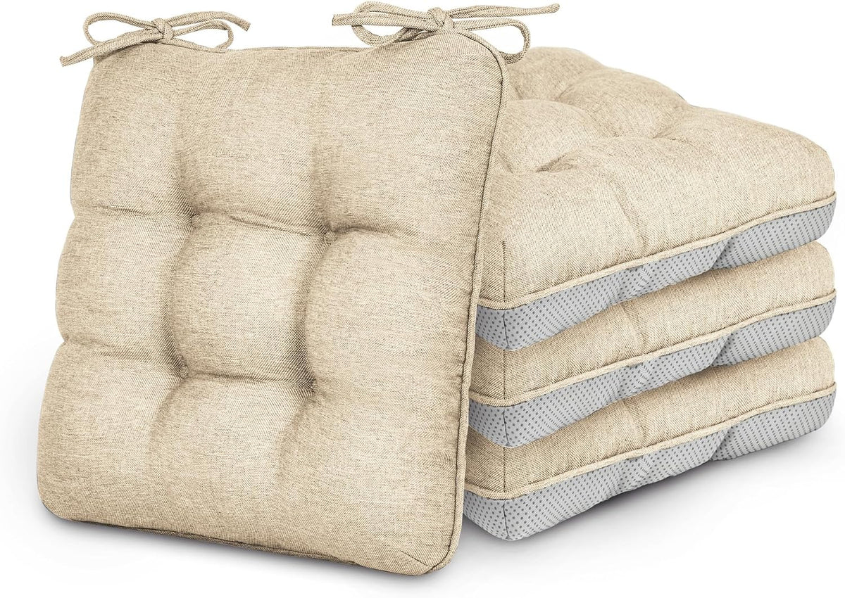 Stack of four beige tufted chair cushions with ties, front cushion leaning against the stack