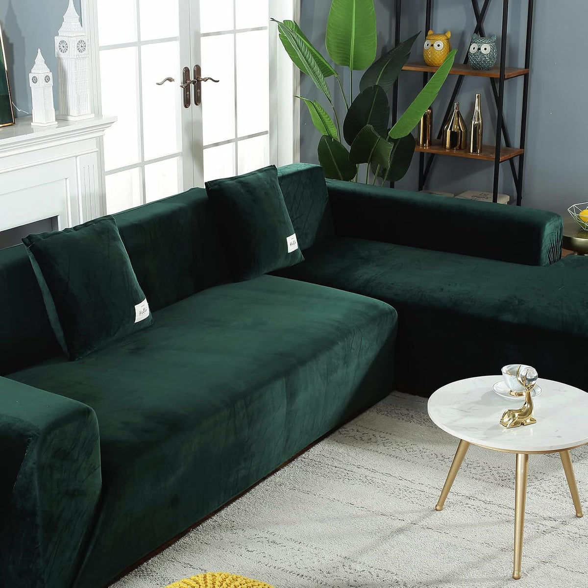Side angle of the dark green slipcovered sectional with decorative shelving behind