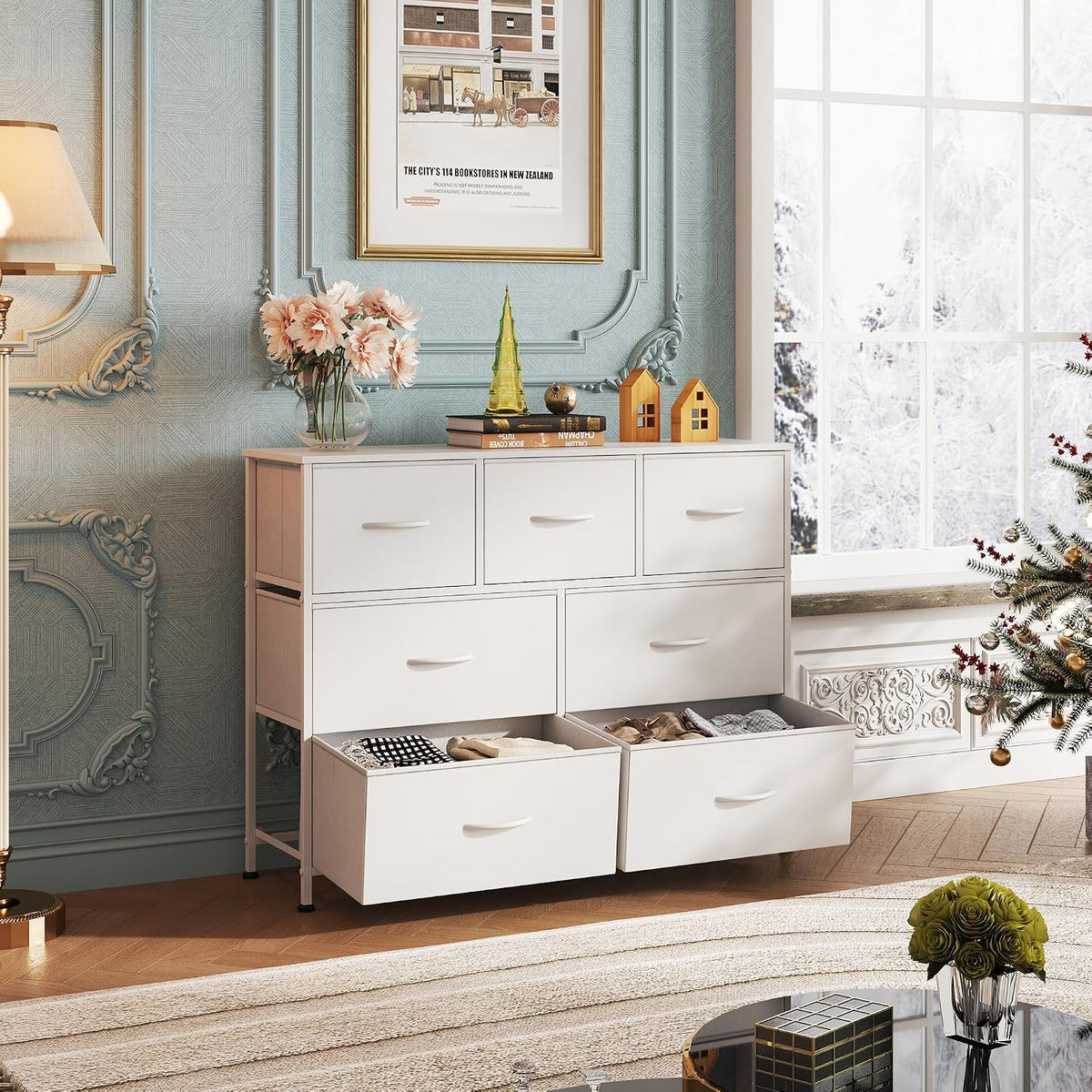 White dresser with open drawers in a decorated living room