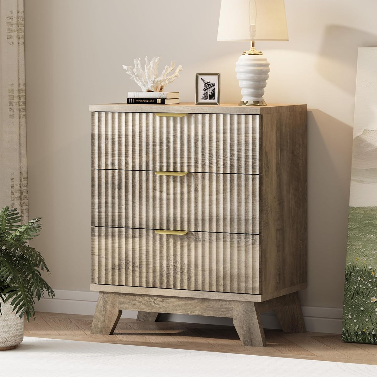 Narrow tall chest in weathered wood finish with wave-panel drawers and gold pulls on angled legs.