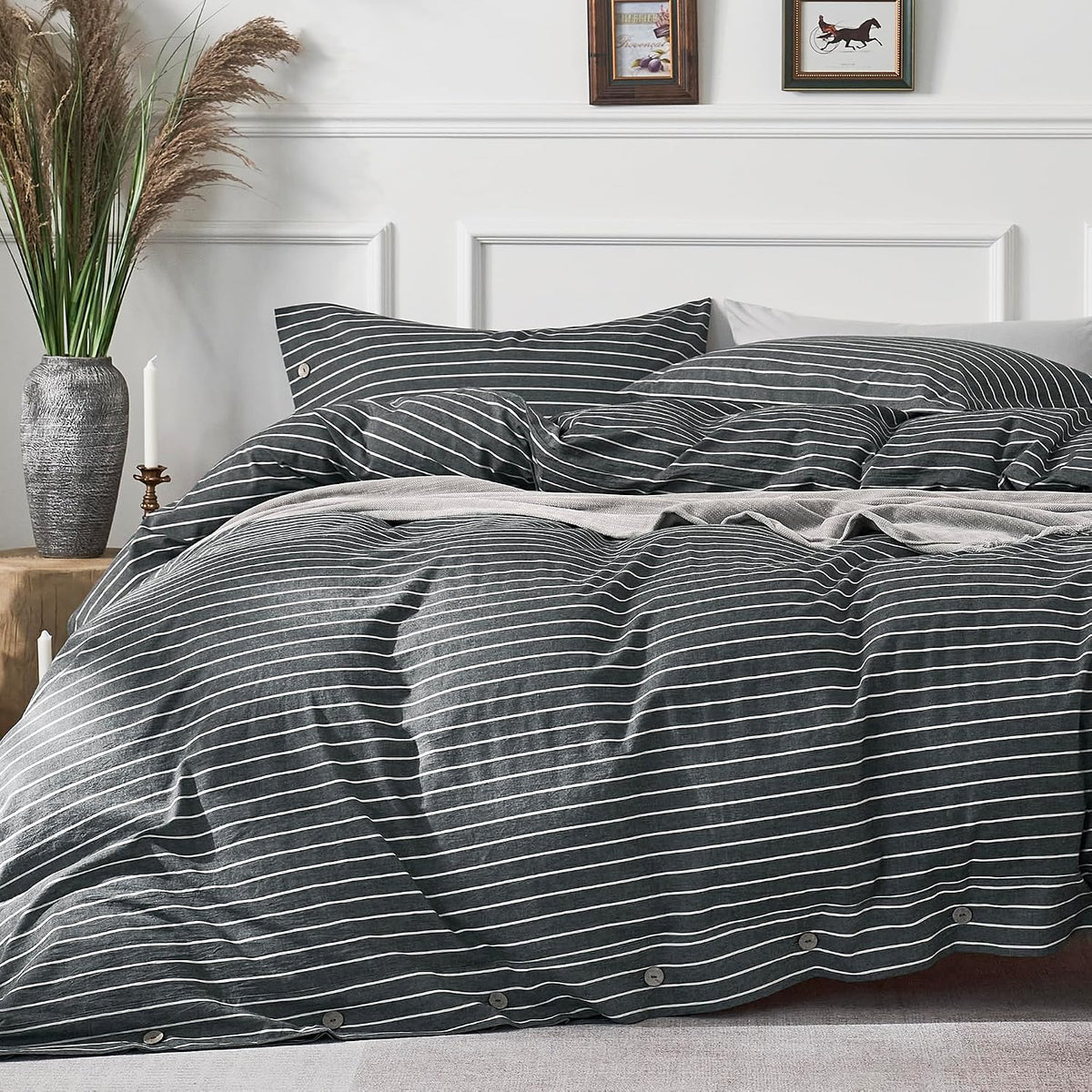 Close-up of charcoal duvet with thin white horizontal stripes and visible wooden buttons along the hem.