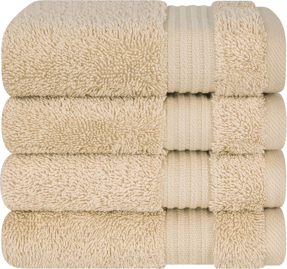 Close stacked view of four beige towels showing plush loops and ribbed border