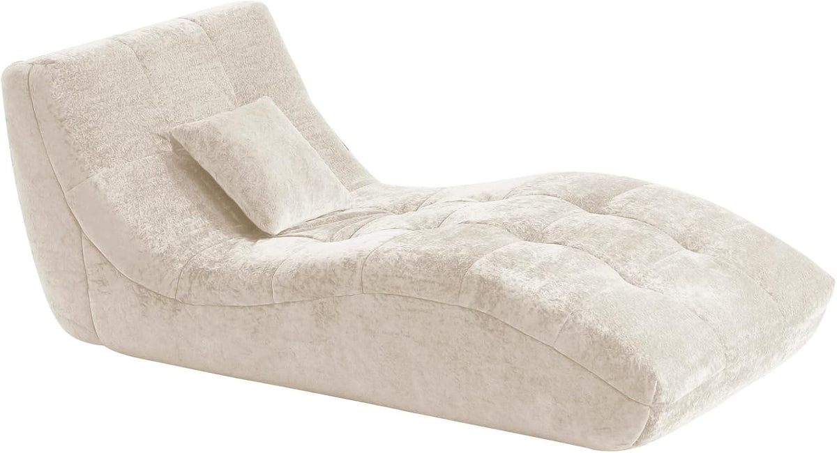 Isolated studio image of the beige chaise showing its curved silhouette and tufting.