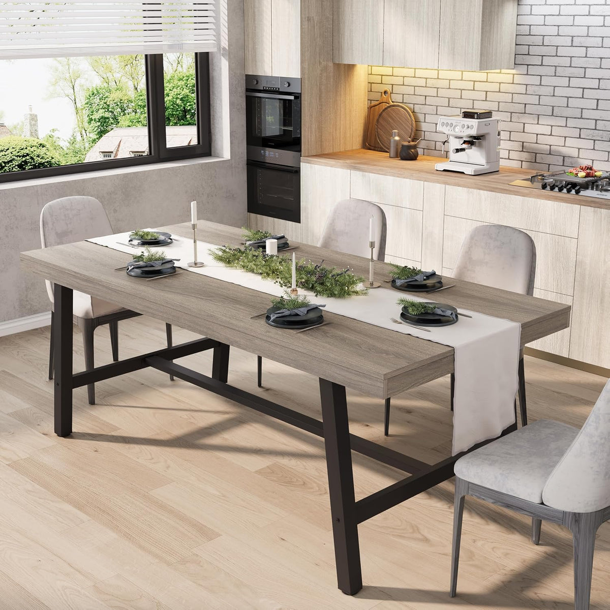 Side view of the long wood tabletop and metal legs set with plates and a fabric runner in a bright kitchen.