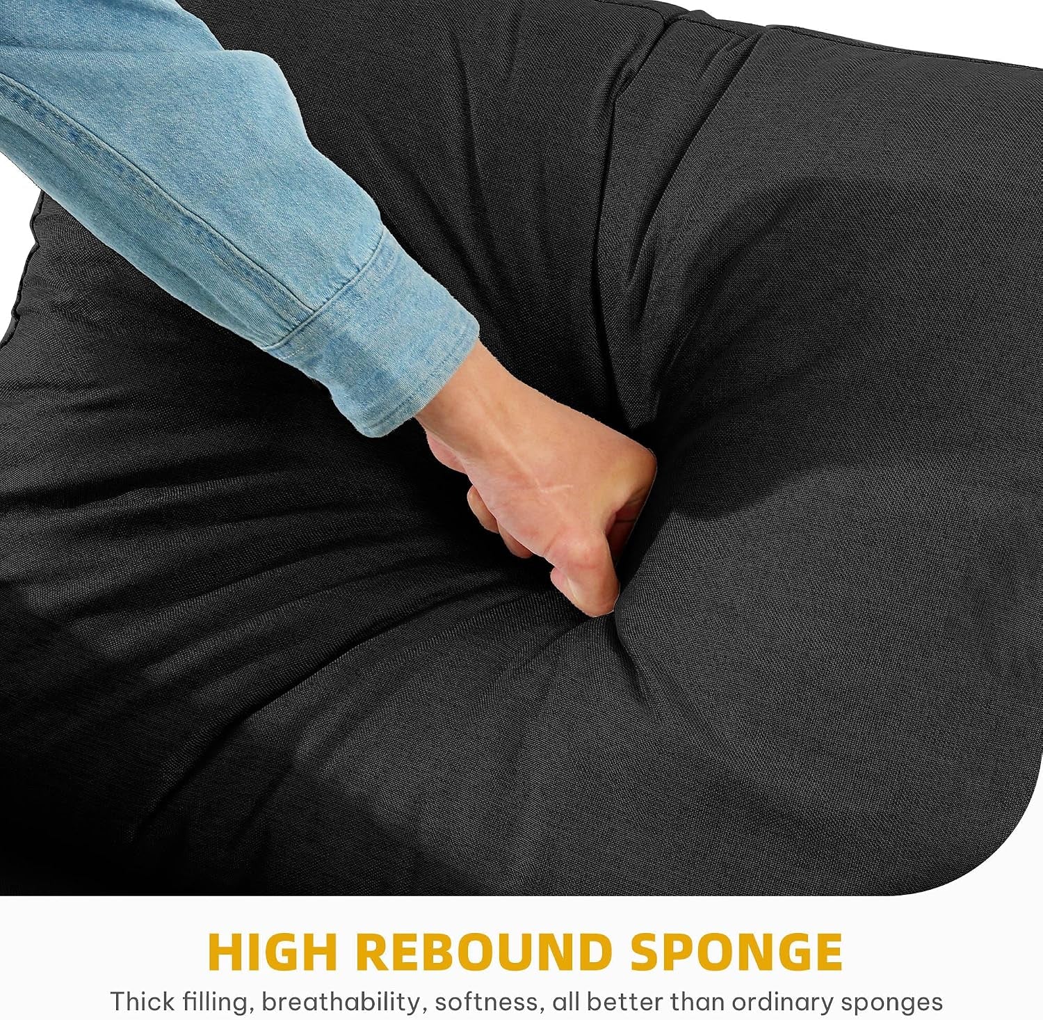 Hand pressing the tufted black linen seat cushion to show soft, high-rebound padding.
