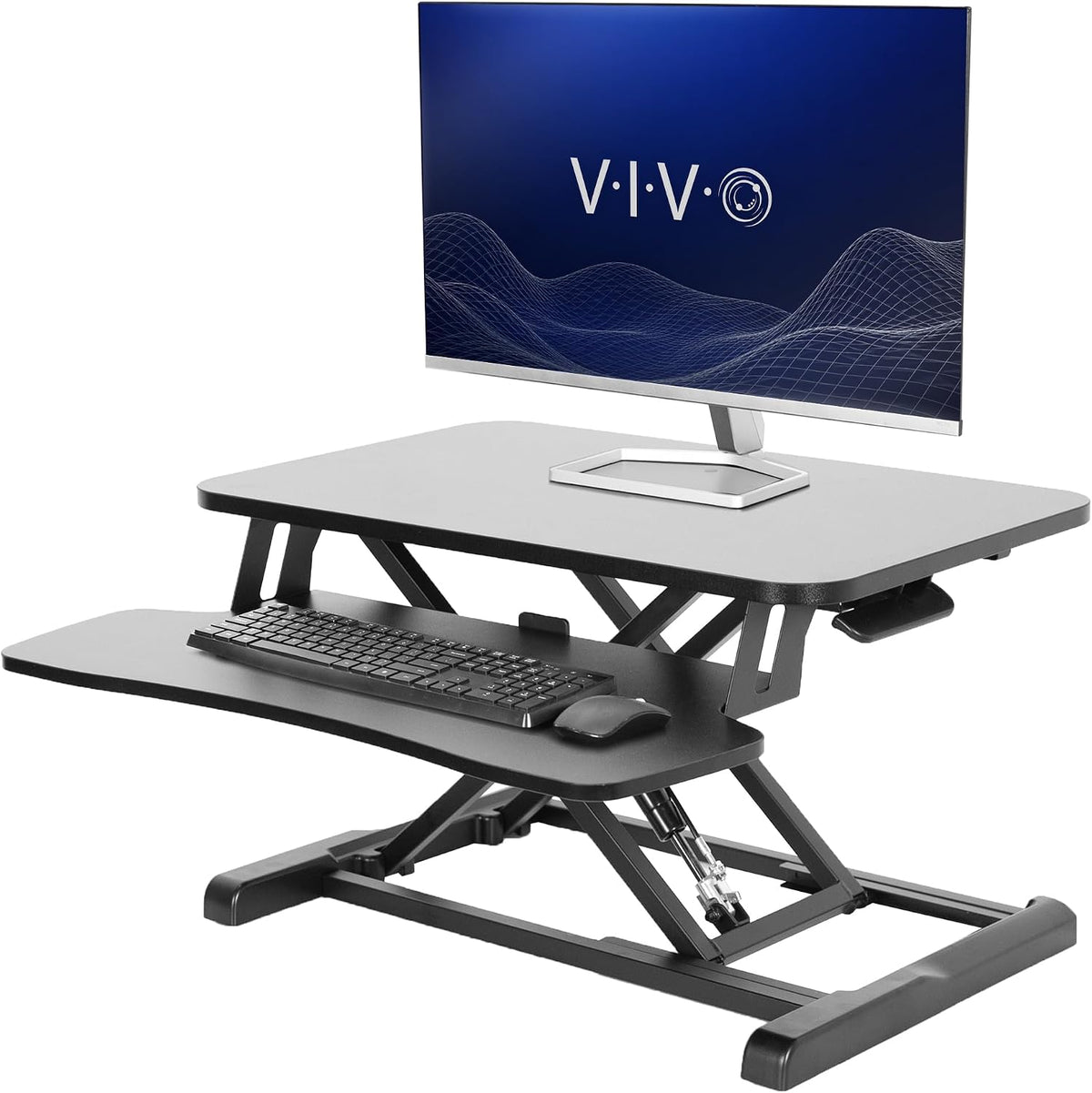 Side view of black standing desk converter with monitor on top and keyboard on lower tray