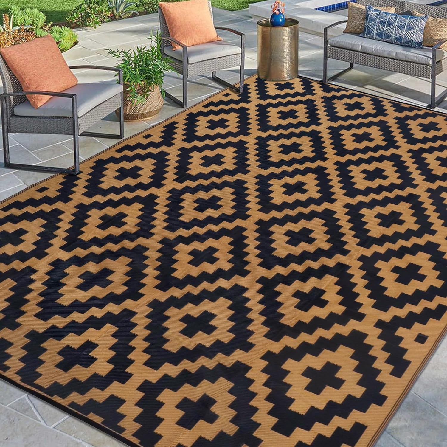 Poolside seating area with a large tan-and-black patterned outdoor rug anchoring chairs and a small table.