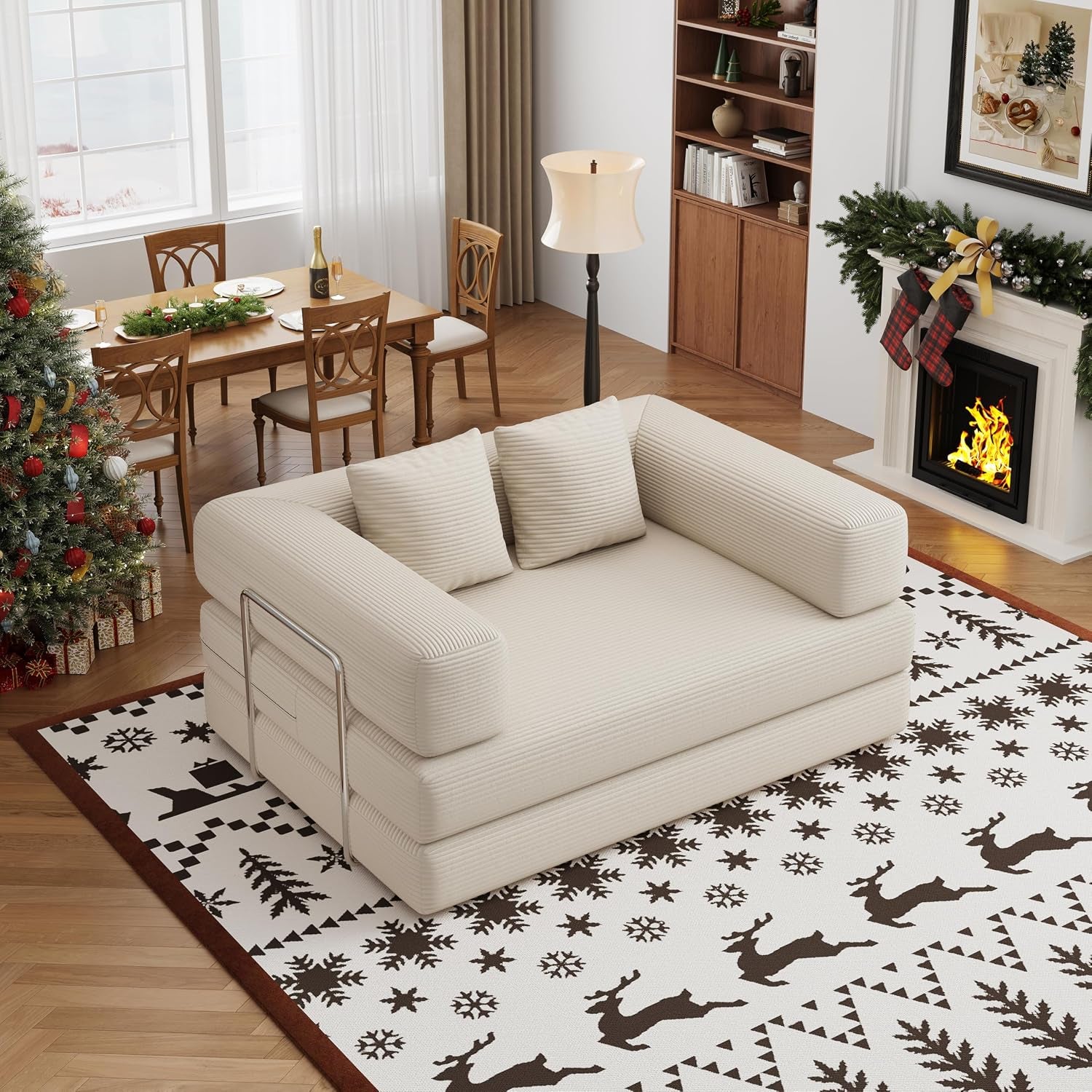 Low-profile beige corduroy two-seat convertible floor sofa placed on patterned rug by a dining area