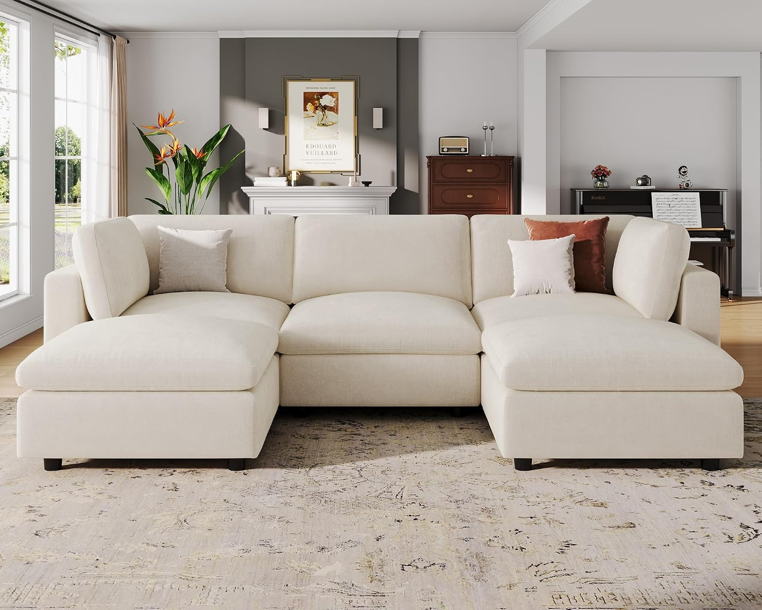 Front view of the sectional showing extended chaise pieces on both ends with pillows