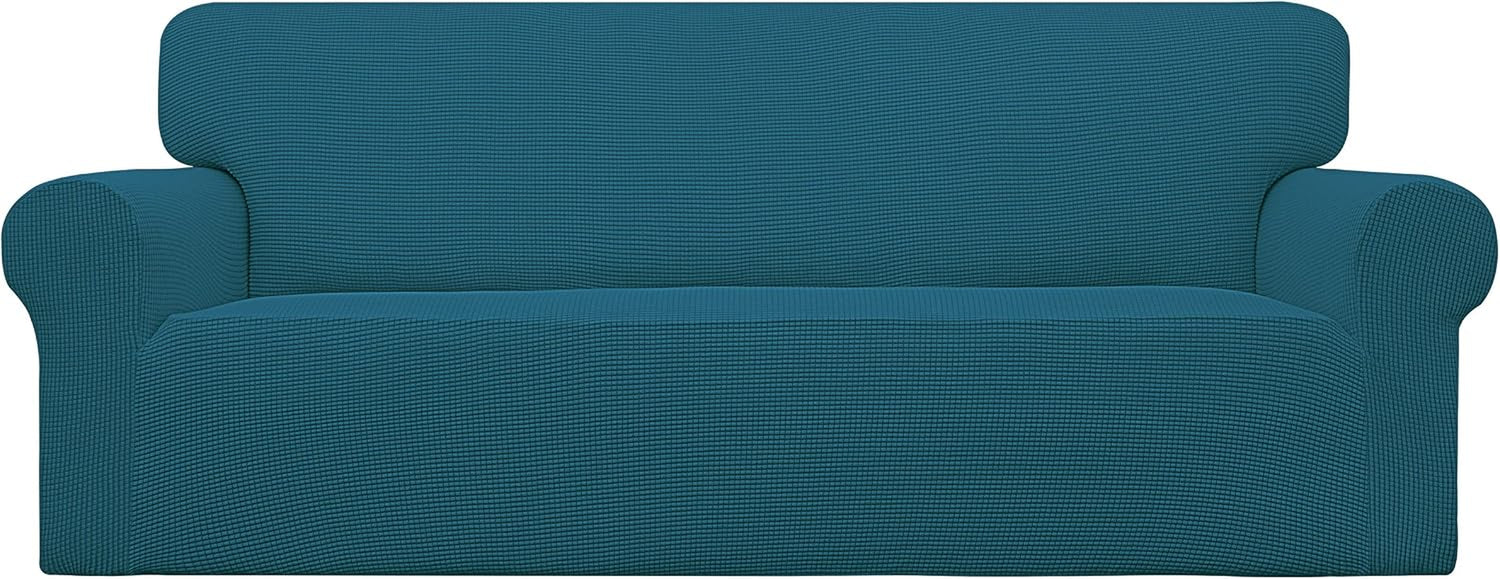 Front-facing loveseat with rolled arms dressed in a teal textured stretch slipcover.