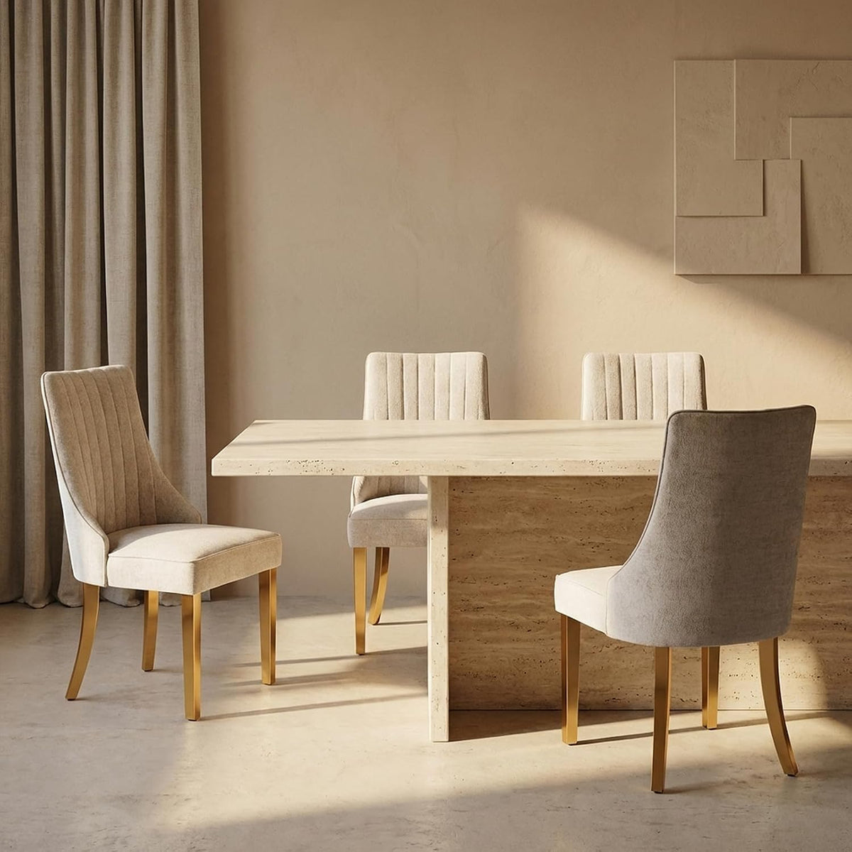 Three beige upholstered dining chairs around a stone table, gold-toned legs visible