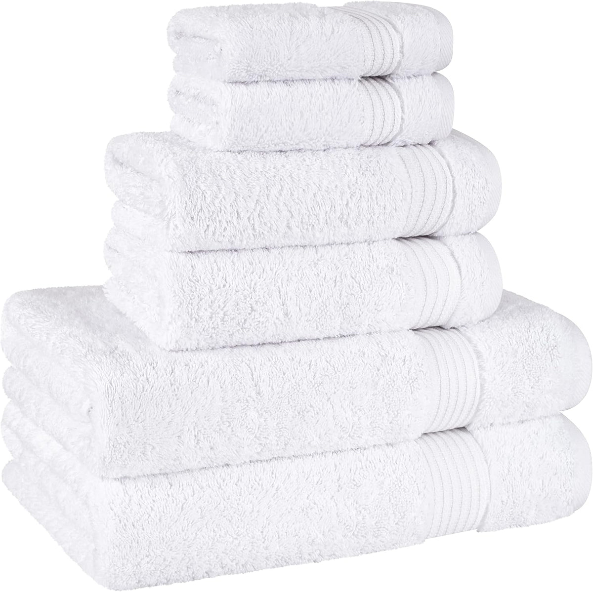Angled stack of white towels showing layered edges and ribbed trim