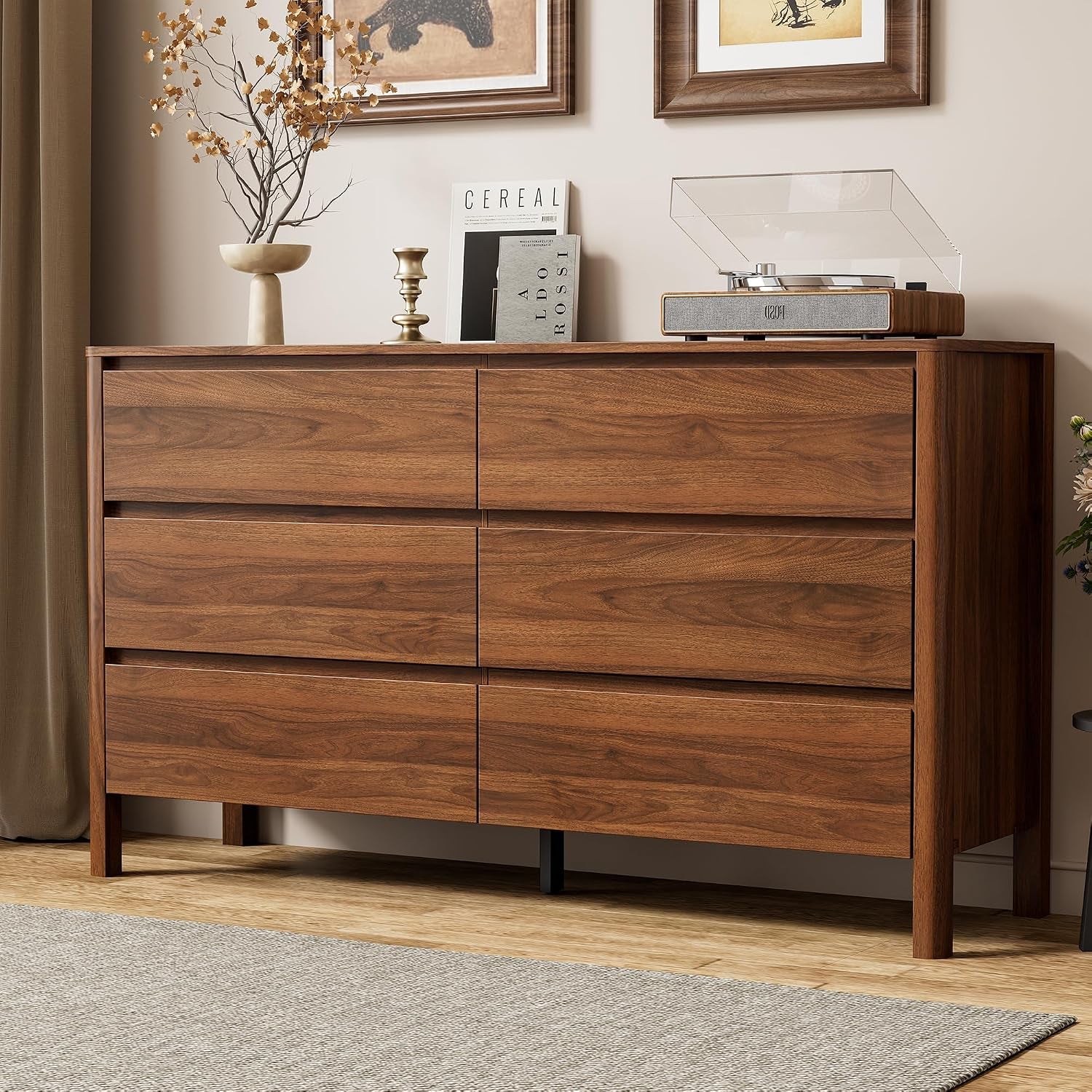 Three-quarter front view of a walnut six-drawer dresser with wood legs in a living room setting