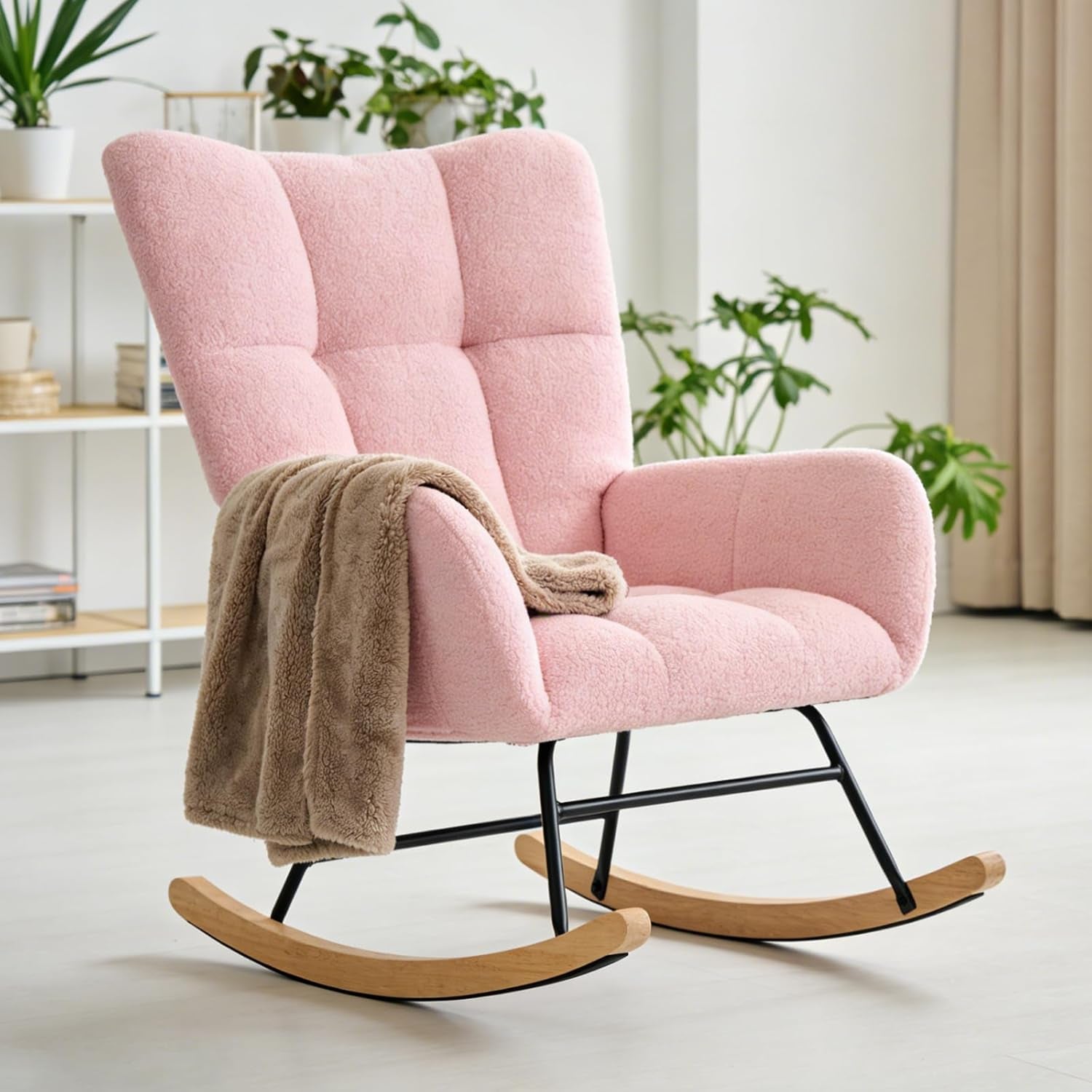 Pink teddy fabric rocking chair angled front view showing padded seat and curved wooden rockers
