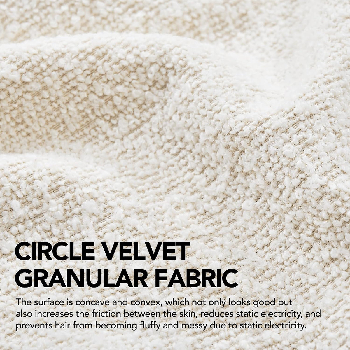Close-up of ivory boucle fabric showing looped granular texture and weave