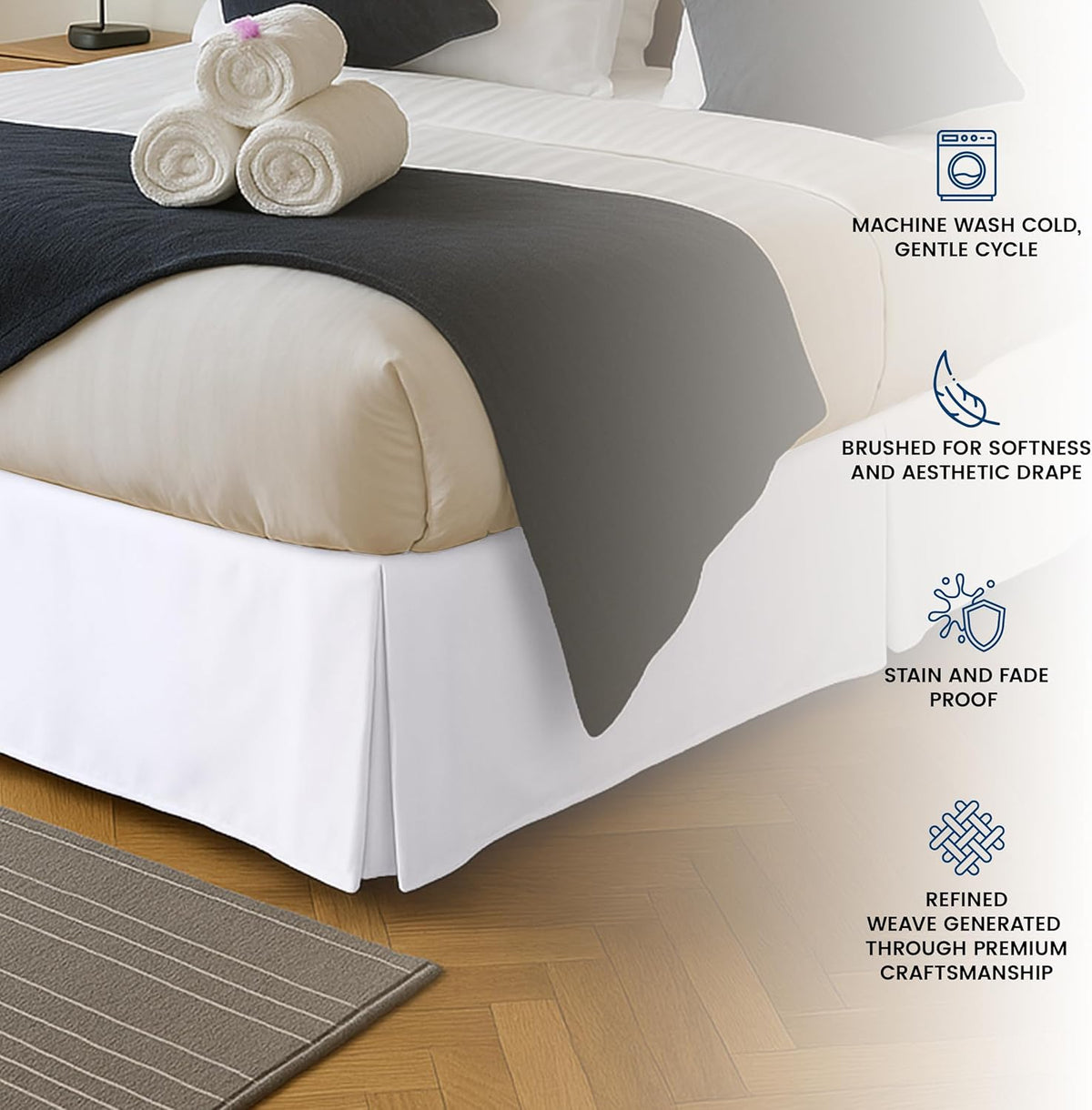 Corner of a made bed showing a white pleated bed skirt with a box-pleat at the corner.