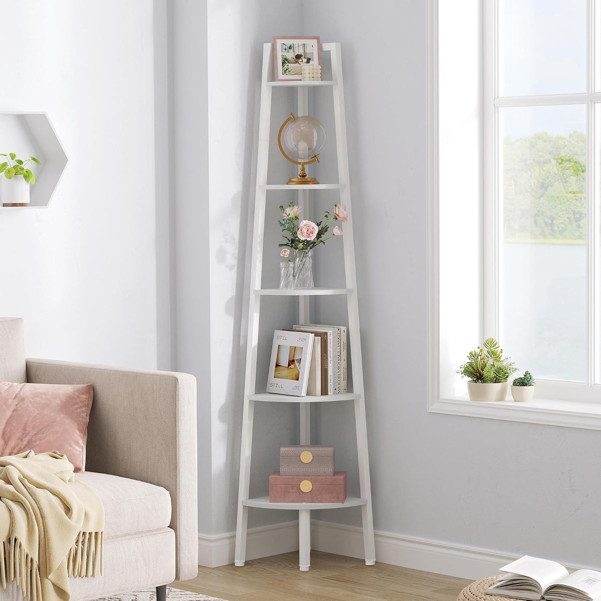White corner ladder shelf displayed in a bright room with pink accents and small potted plants