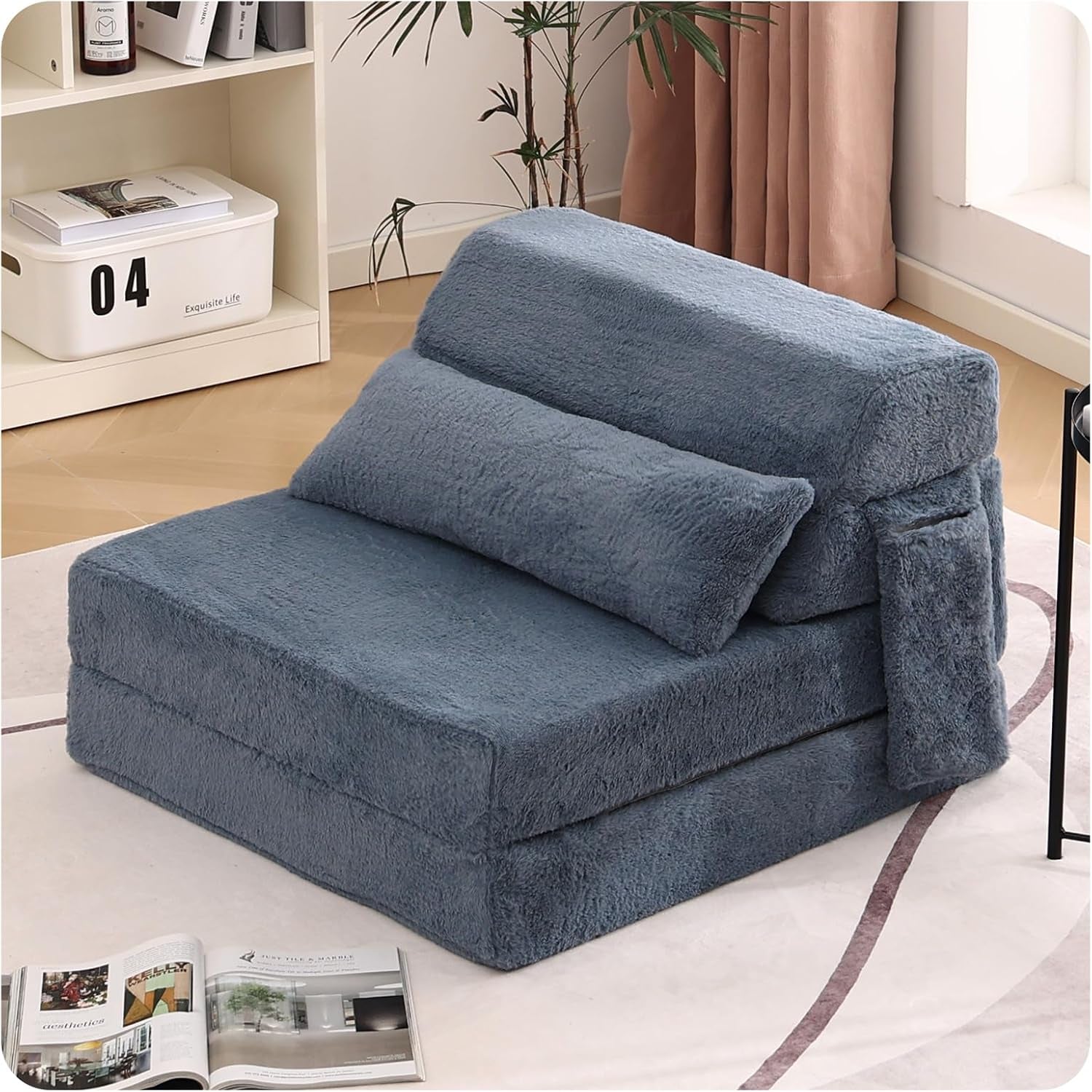 Folded blue-gray plush convertible floor mattress set up as a single-seat chair with lumbar pillow and side pocket