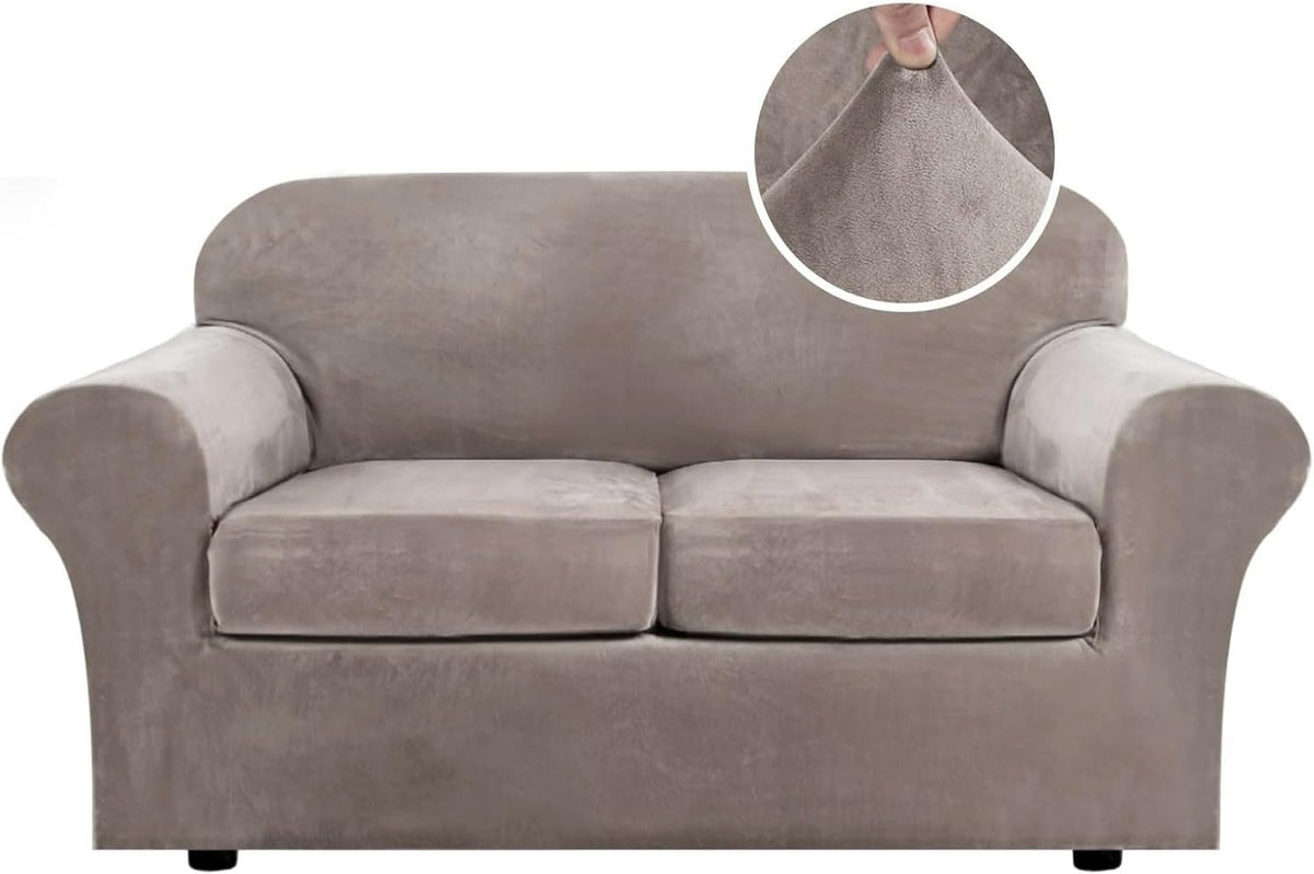 Front-facing loveseat covered in a taupe velvet slipcover with two separate seat cushions and a round inset of someone