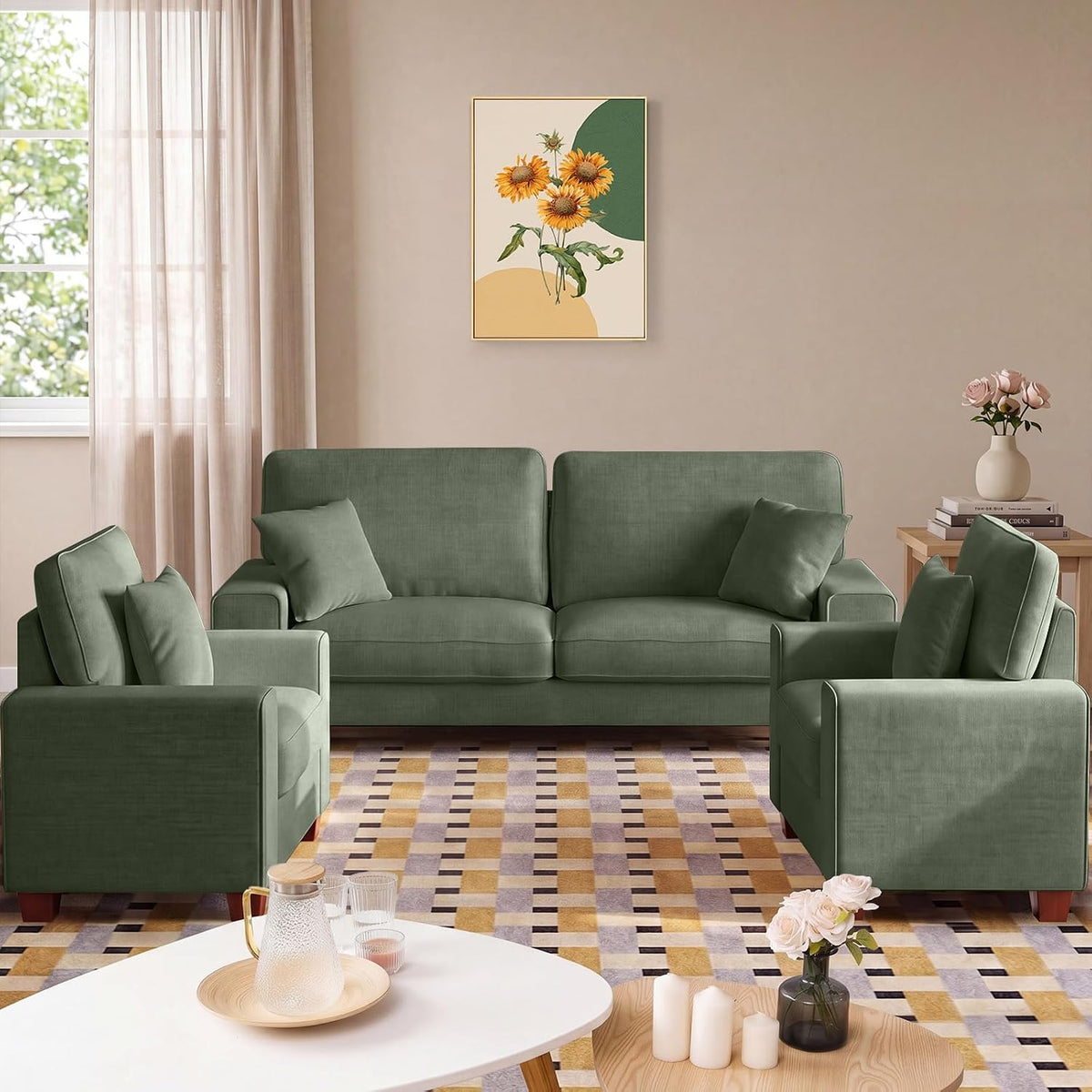 Green loveseat flanked by two matching chairs in a staged living room with wall art and side table