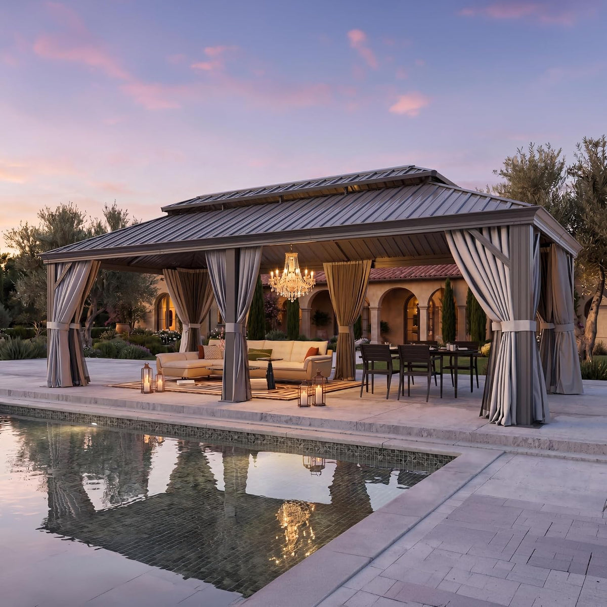 Pool-front view showing the gazebo and its chandelier reflected in calm water, lanterns on the deck and seating inside.