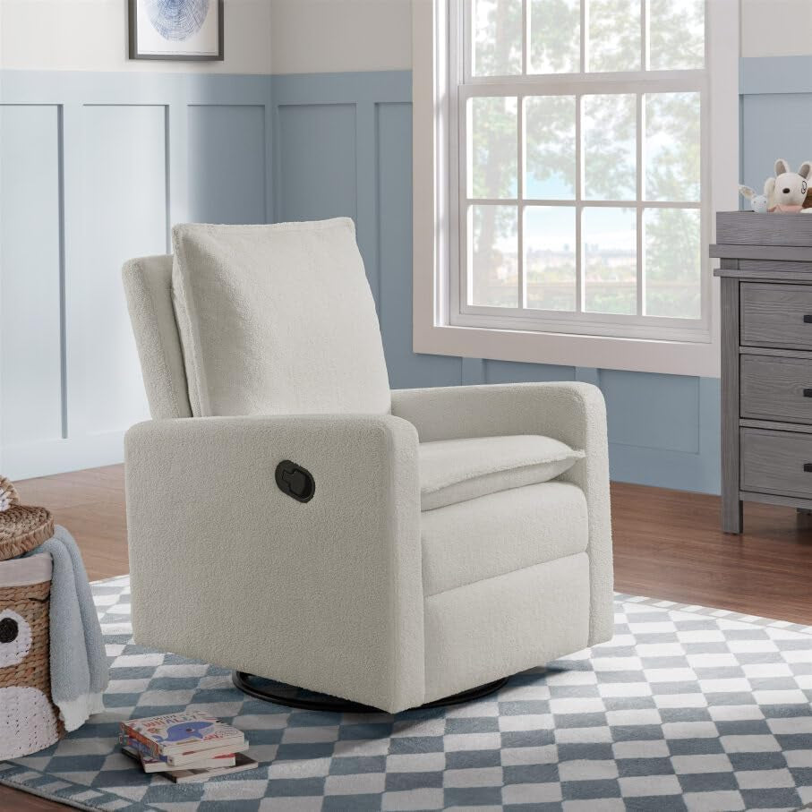 White boucle swivel glider recliner in a light nursery by a window on a patterned rug.
