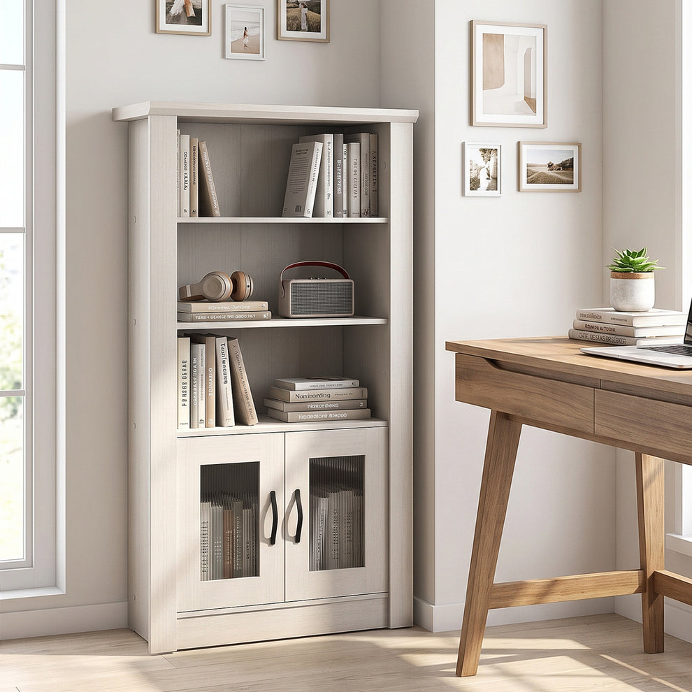 White bookcase with books and decor in a bright home office beside a wooden desk.