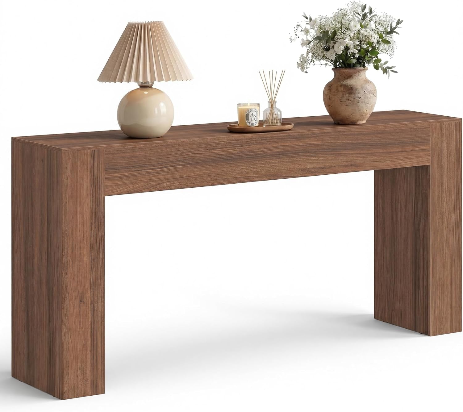 Angled front shot of the console in a warm medium-brown wood finish with lamp and flowers.