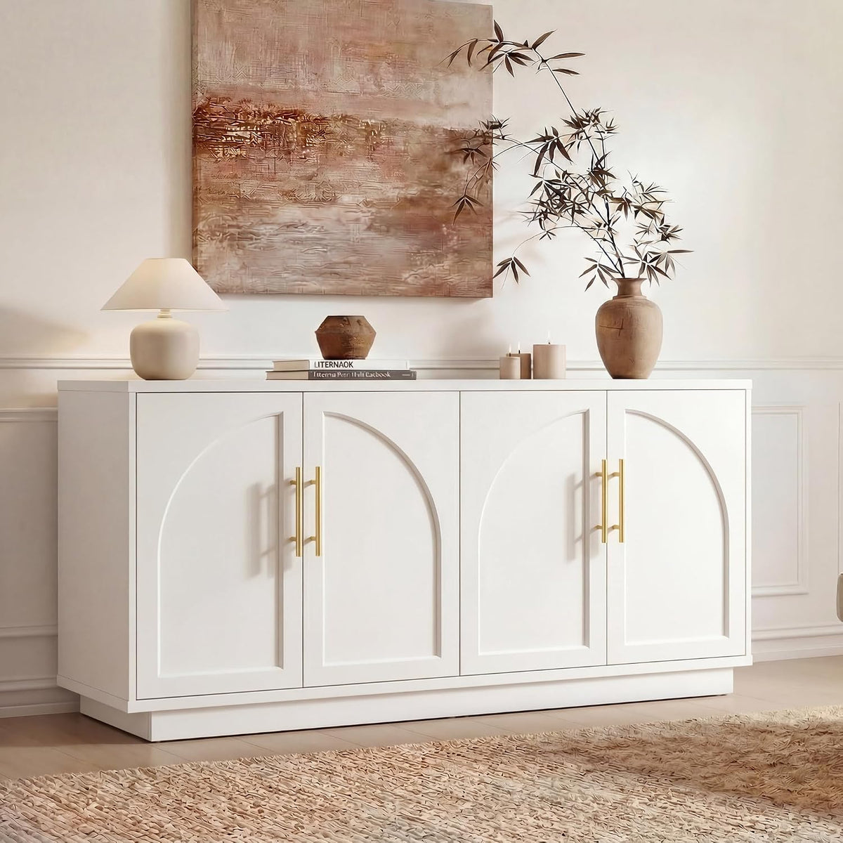 Low-angle detail showing the cabinet's raised base, gold handles, textured rug and decorative lamp and vase on top.