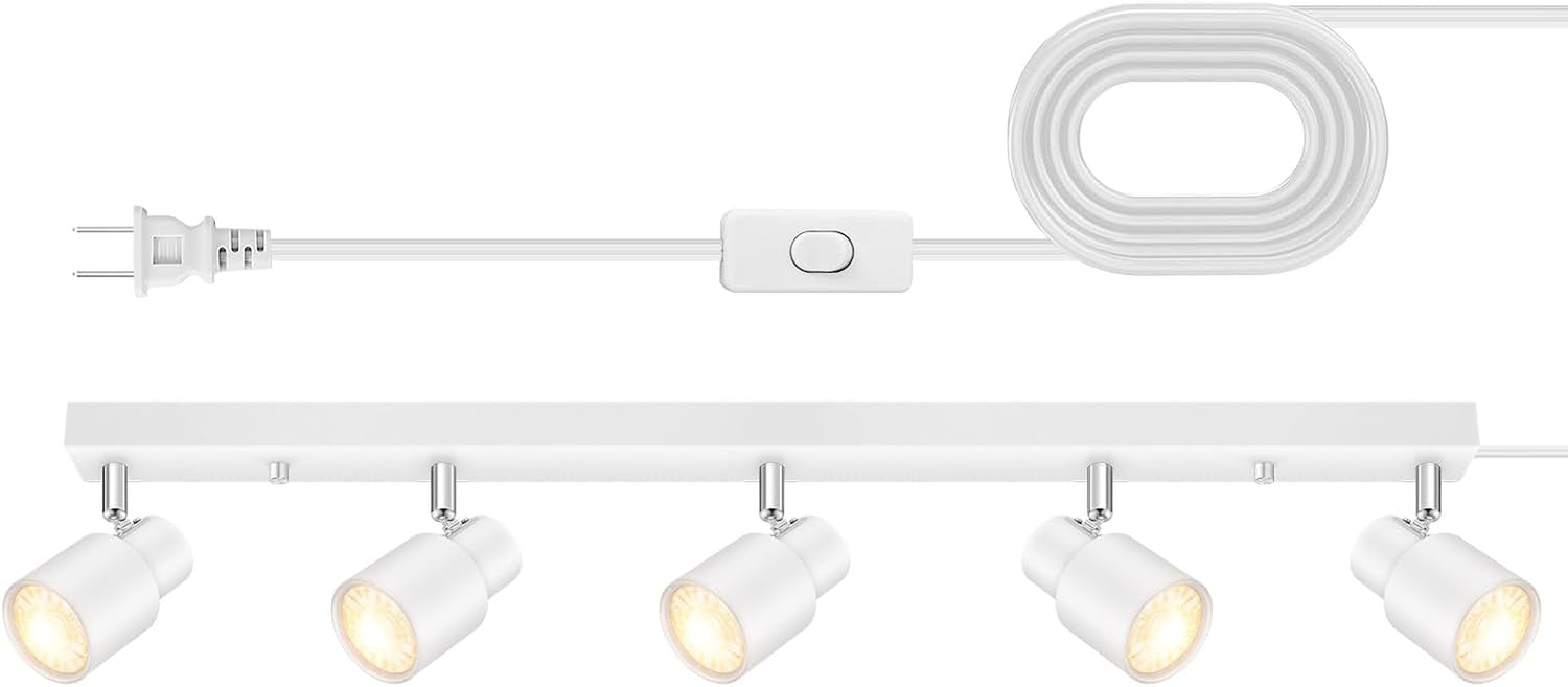 White track fixture shown flat with four lit spotlight heads, coiled white cord and inline rocker switch