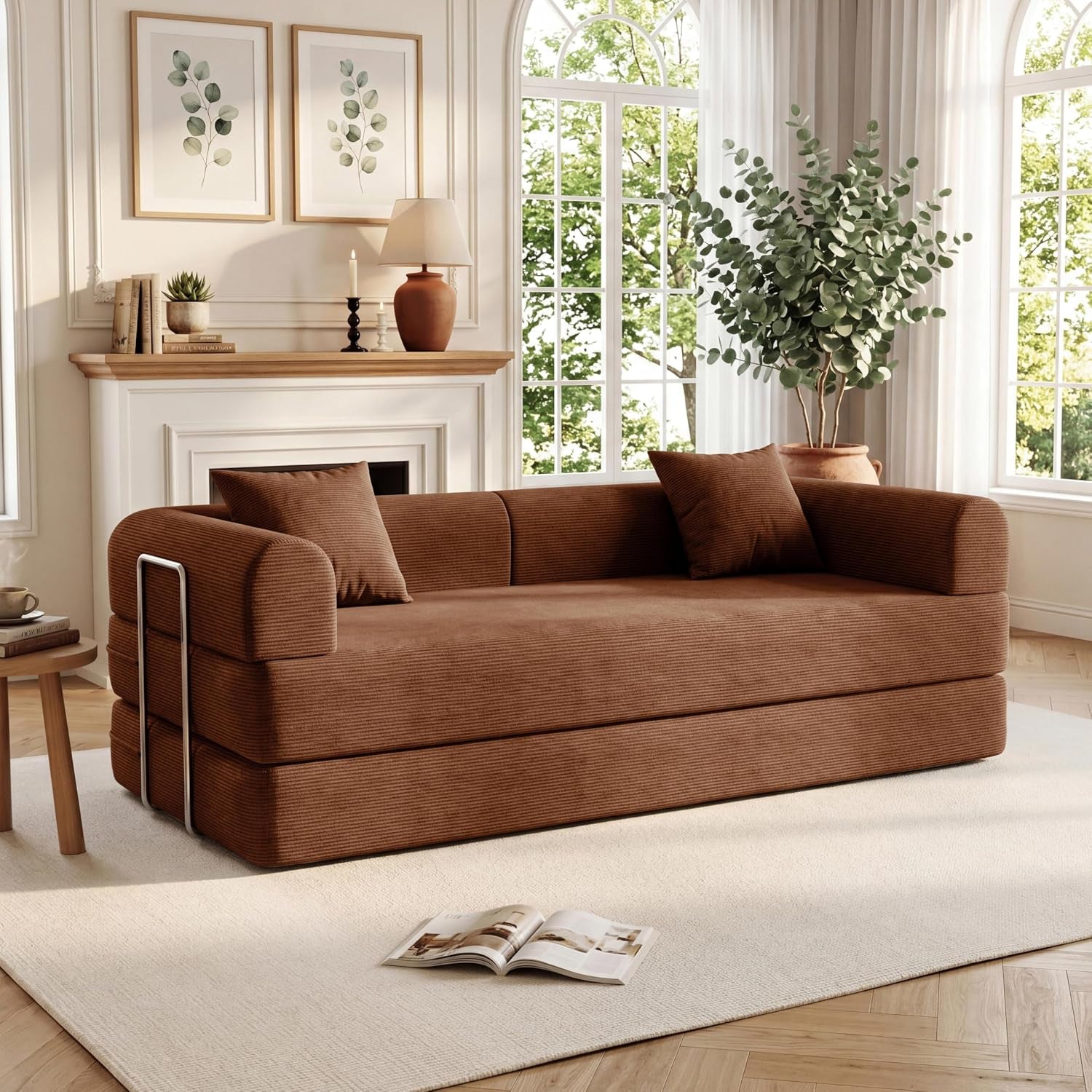 Warm brown corduroy convertible sofa with two pillows in a sunlit room beside a small side table.