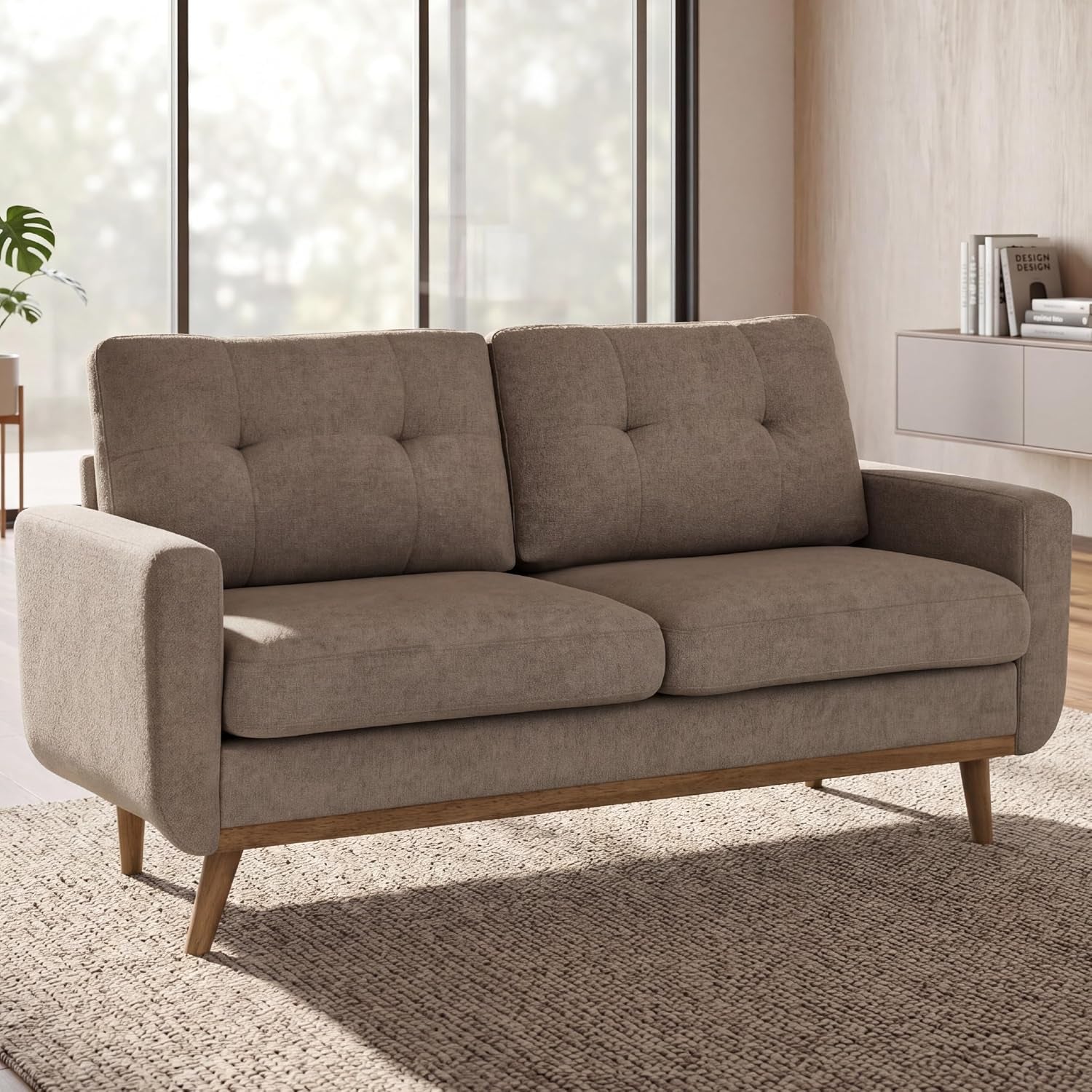 Three-quarter front view of camel loveseat futon highlighting armrest and tufted back in bright room