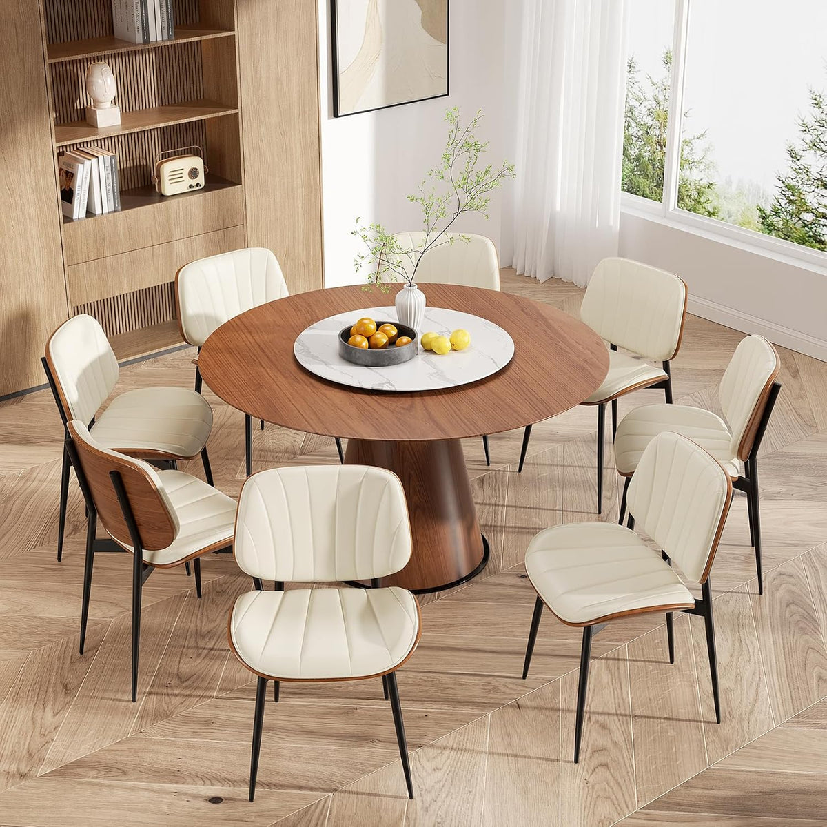 Overhead view of a round table set with cream faux-leather chairs showing wood chair backs and black legs.